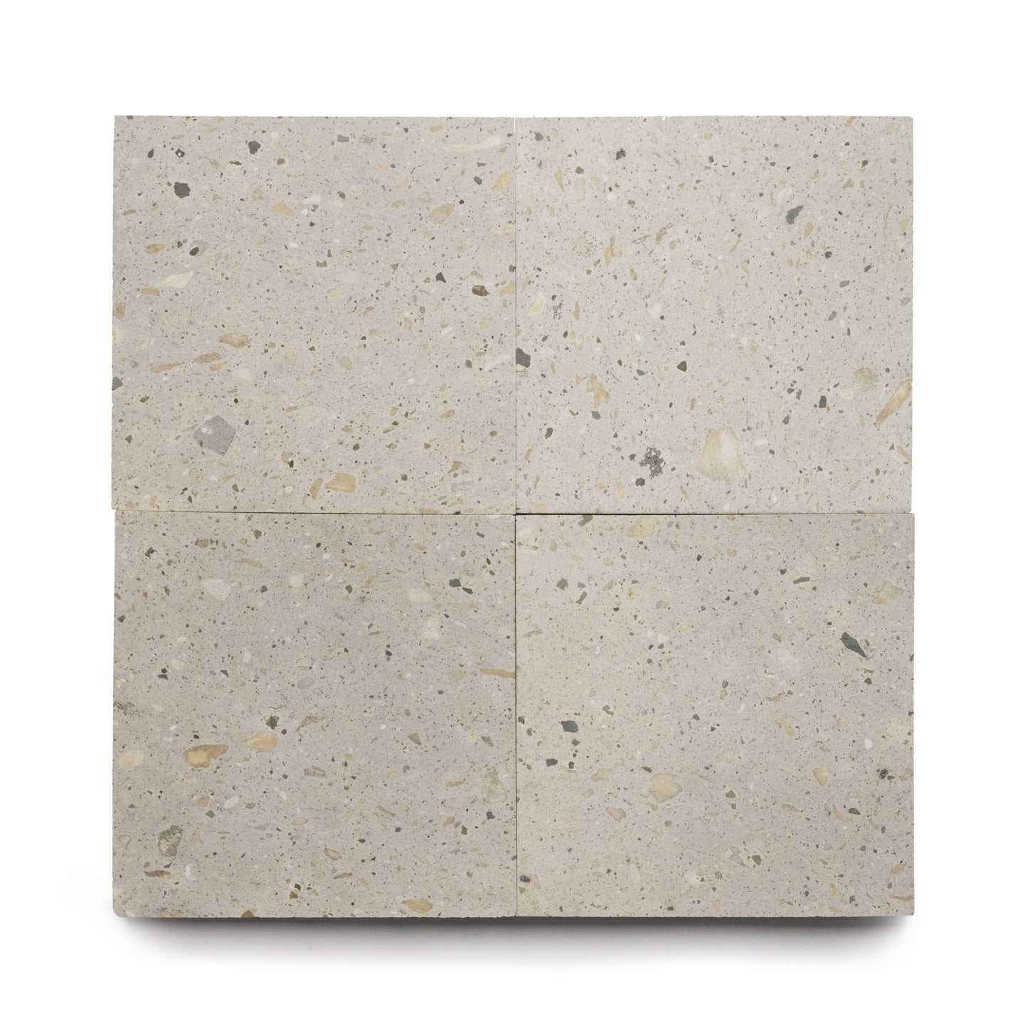 Four Acacia 24x24 tiles by Zia Tile, square and beige with light and dark flecks, are arranged in a grid on a white background. Made from volcanic stone, the tiles feature a matte finish and subtle natural stone texture.