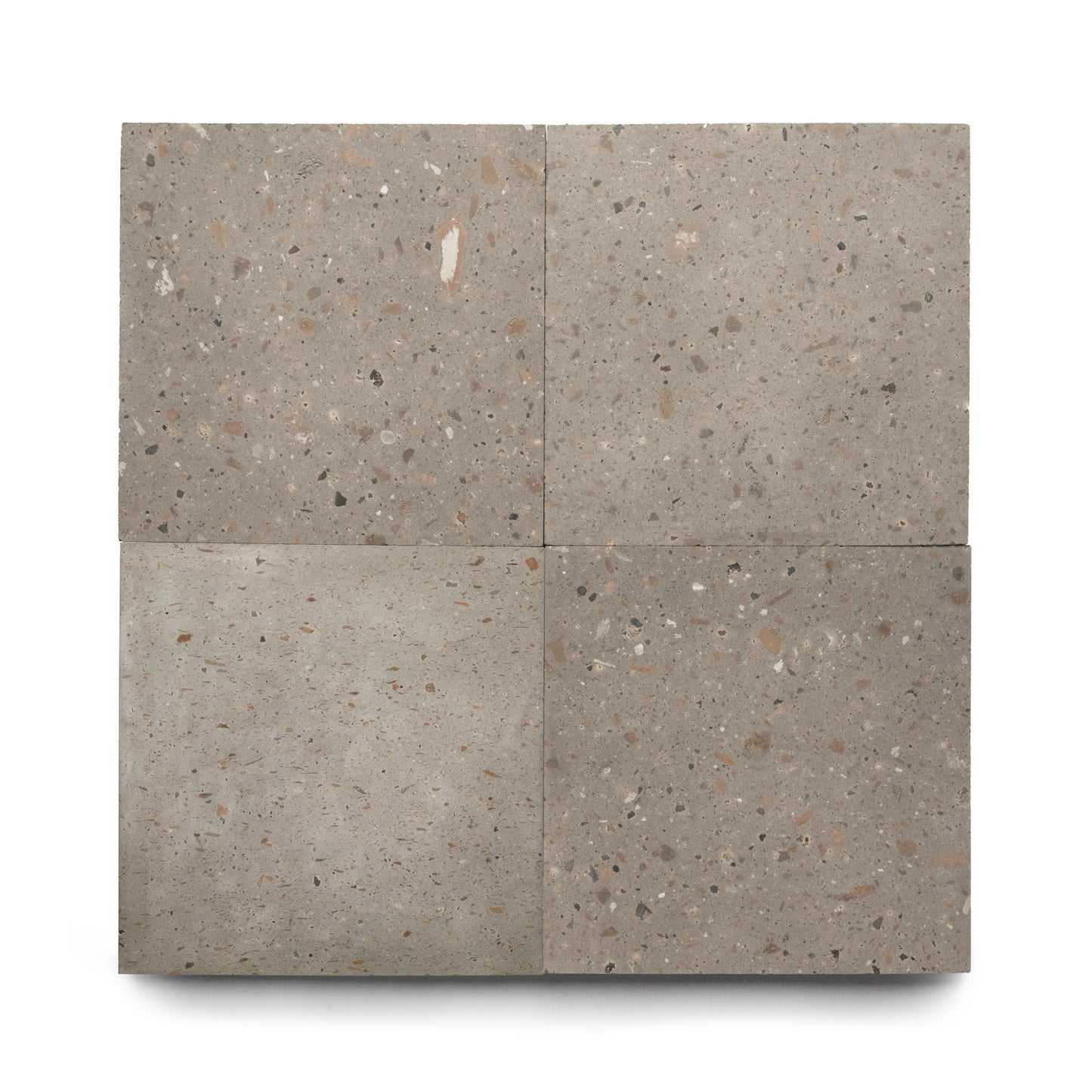 Four Badlands 24x24 tiles by Zia Tile, arranged in a 2x2 grid, display unique gray volcanic stone patterns with speckled aggregate on a white background, highlighting the natural beauty of Cantera stone.