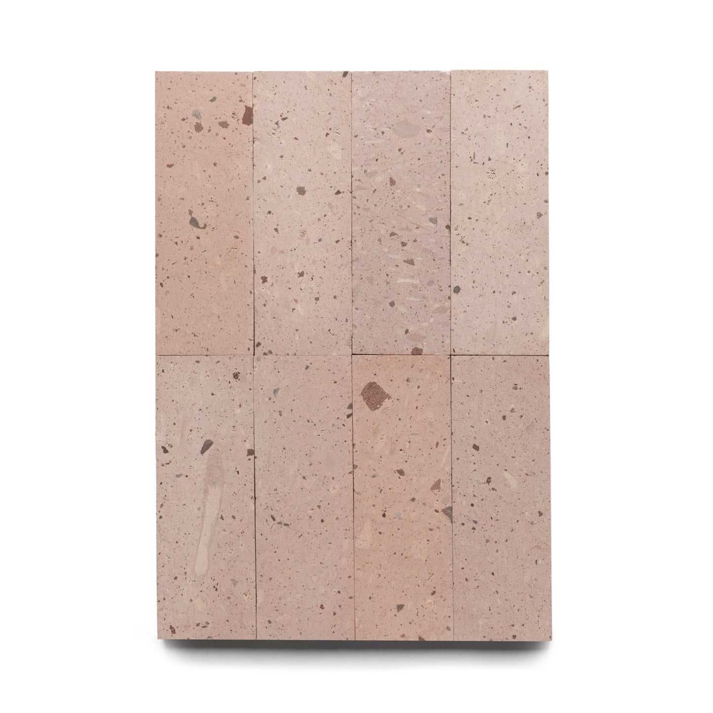 A rectangular arrangement of eight Yuma 4x12 light pinkish-brown terrazzo tiles by Zia Tile, crafted from genuine Cantera stone with scattered darker flecks and spots, displayed on a white background.