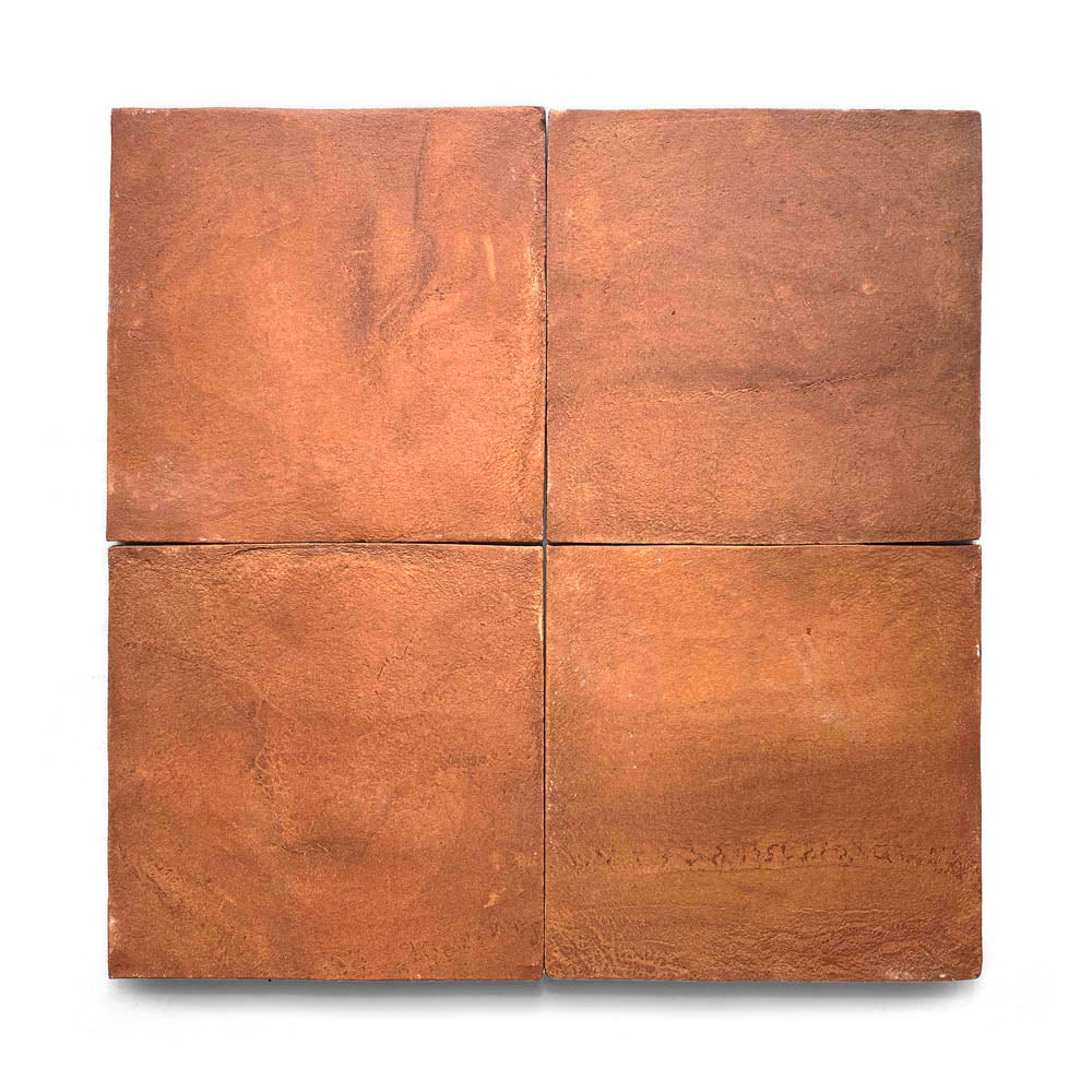 Four 8x8 Square + Red Clay tiles are arranged in a 2x2 grid. Handmade with unique surface variations, these tiles offer a natural, earthy reddish-brown hue and subtle texture inspired by San Miguel de Allende.