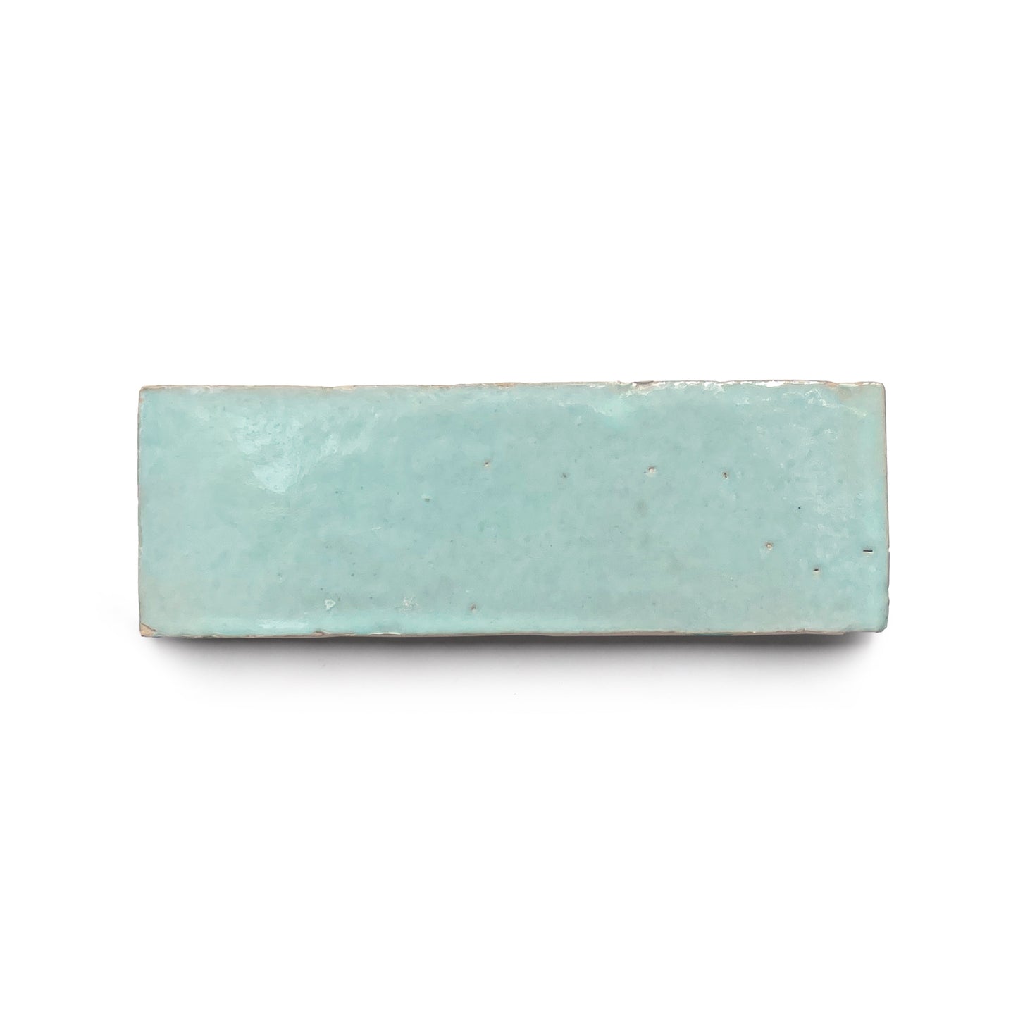 The Absinthe 2x6 is a rectangular ceramic tile with a glossy light blue glaze, evoking classic Moroccan zellige style—perfect for adding charm to any kitchen backsplash against a crisp white background.