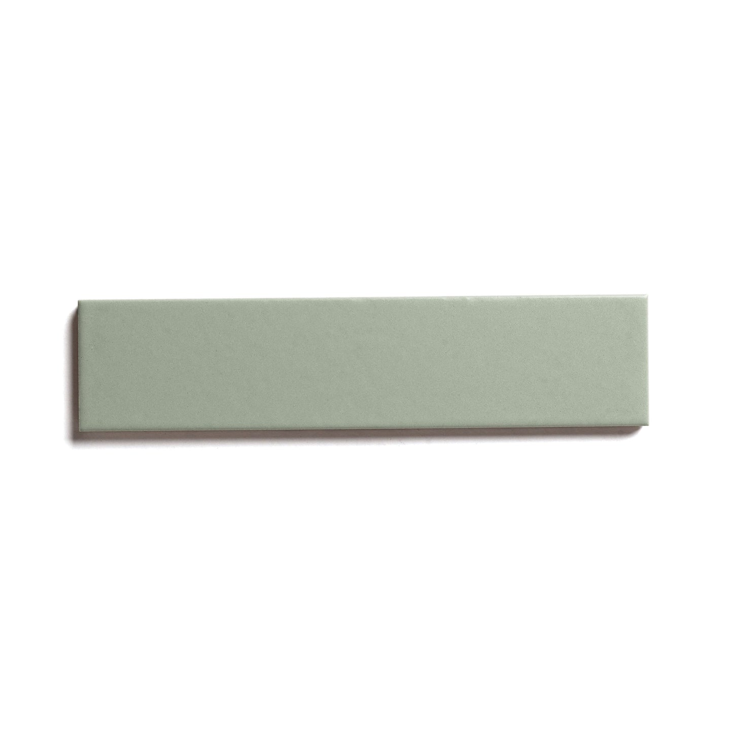 The Balsam 2x8 by Zia Tile is a rectangular, flat ceramic tile in a sage green matte finish, displayed on a white background with a subtle left shadow—perfect for indoor or outdoor spaces.