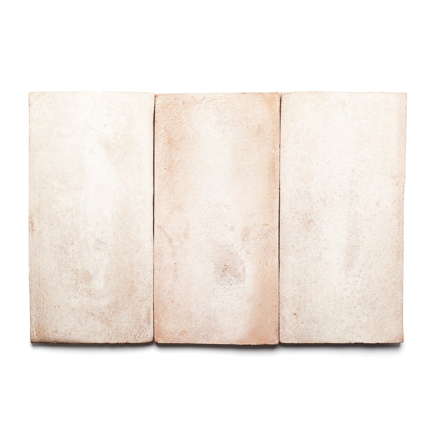 Three 6.5x13 Blanco rectangular tiles by Zia Tile, in light beige with subtle texture and color variations reminiscent of handmade Cotto terra cotta, are arranged side by side on a white background.