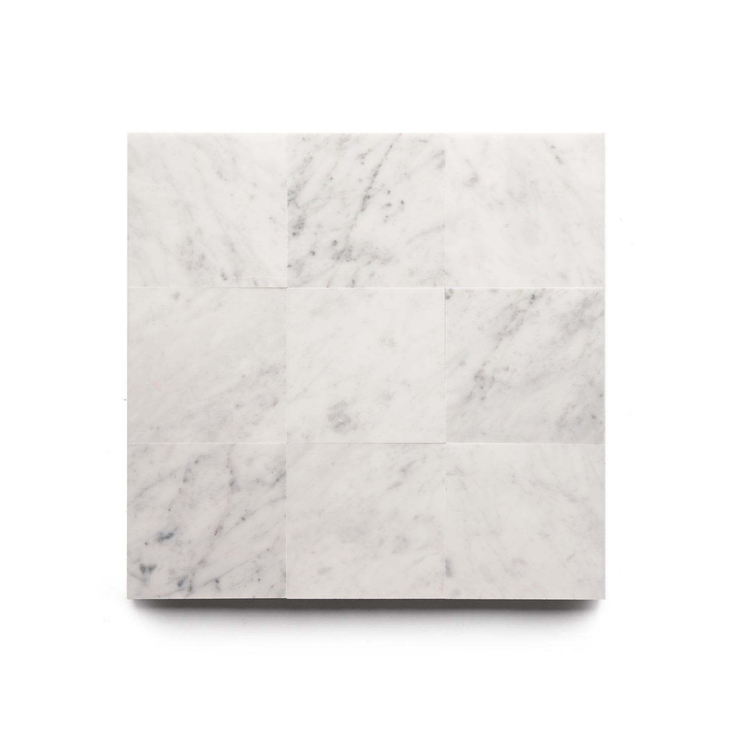 A square layout of nine Carrara 6x6 white marble tiles by Zia Tile, featuring subtle grey veining on a plain white background—ideal for pairing with Zia Tile’s handmade collections.