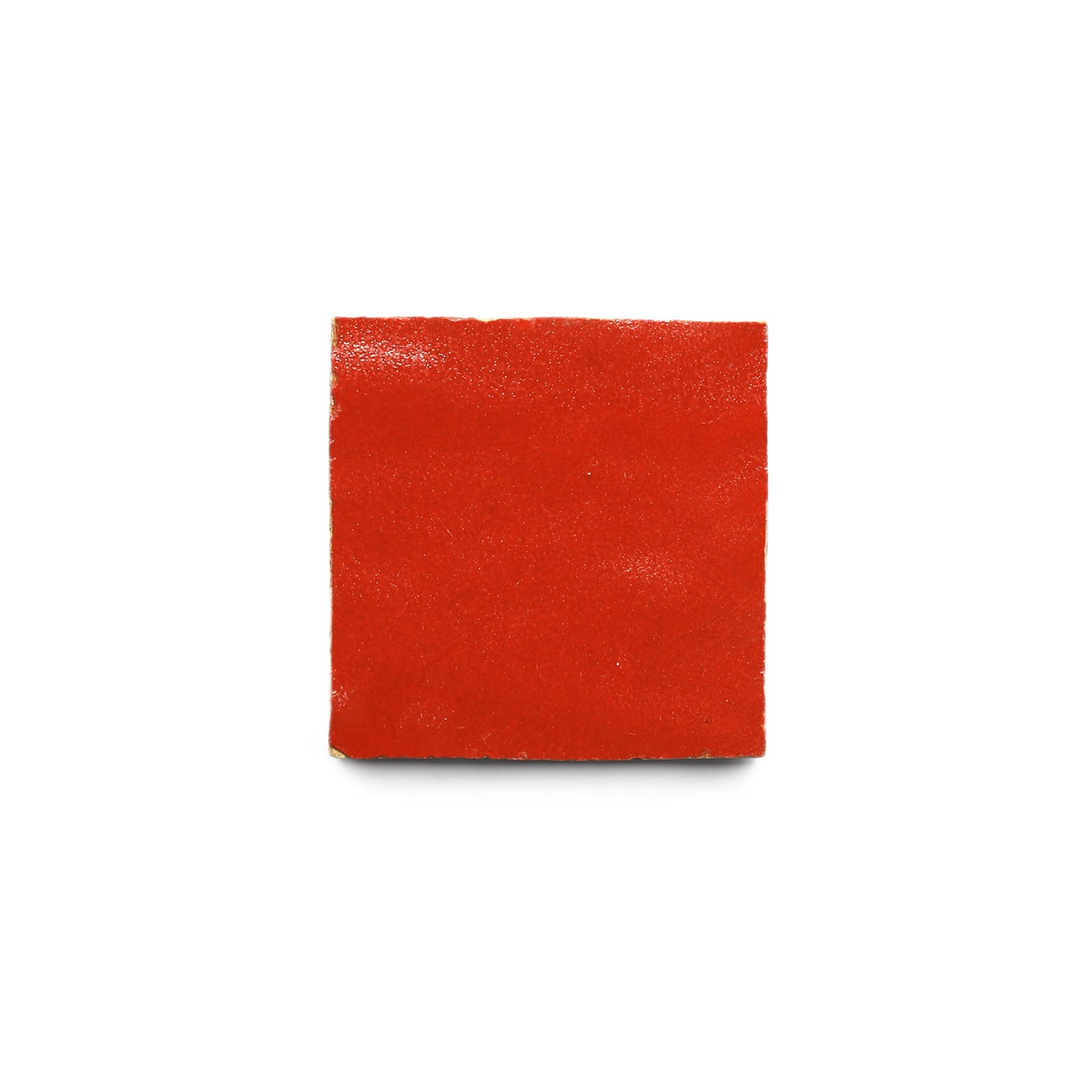 A single, square piece of bright red fruit leather sits centered on a white background, its color echoing the rich hues of Zia Tiles Cayenne 2x2 tiles.