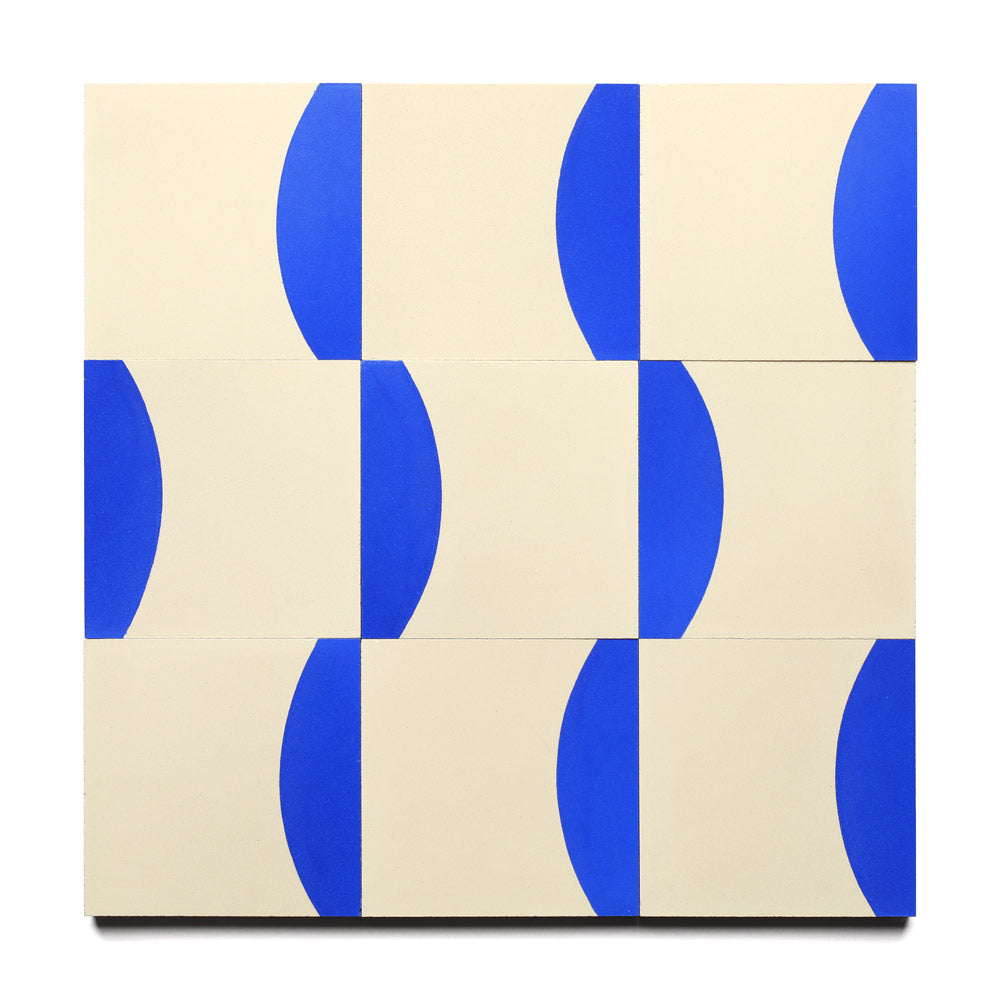 The Coupe Elemental Blue 4x4 by Zia Tile showcases a grid of twelve rectangles on a cream background, each with a bold blue semicircle, forming a repeating geometric tile-inspired pattern.
