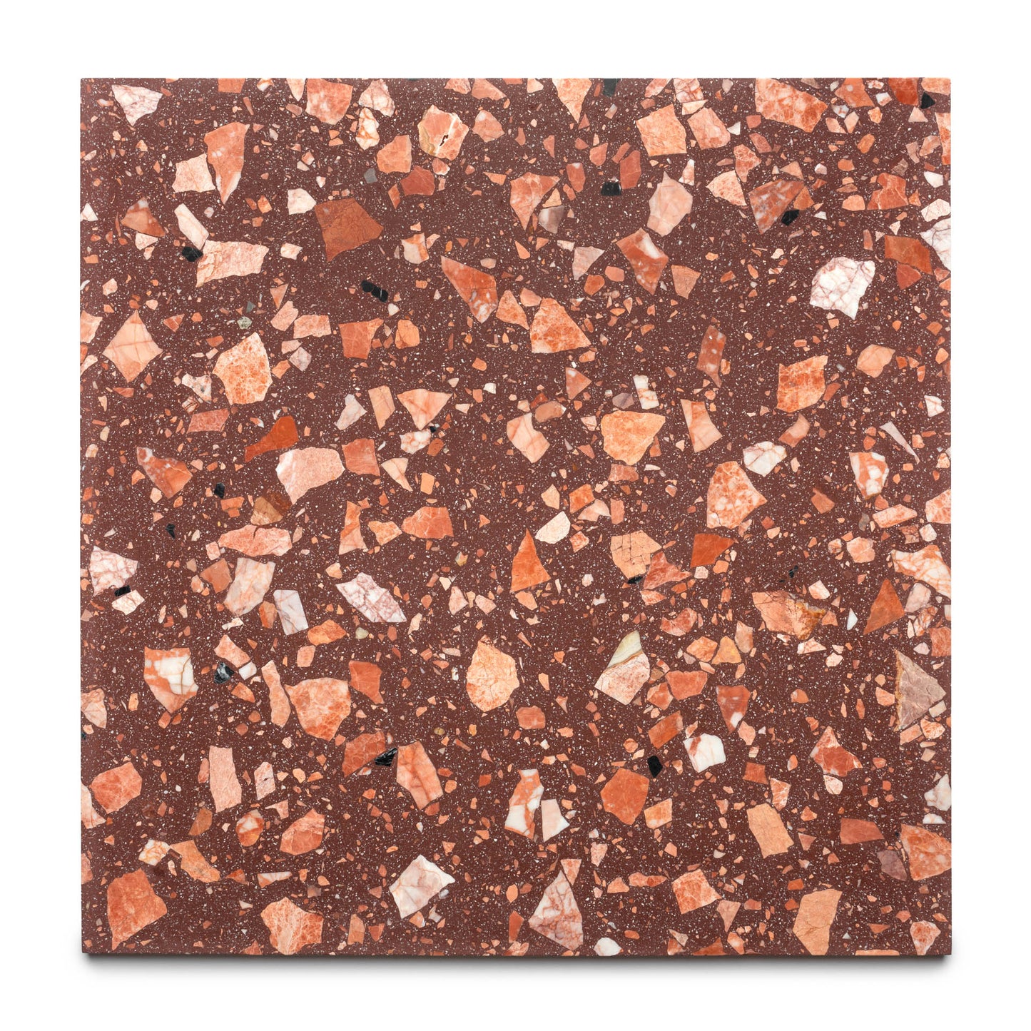 The Date Palm 24x24 by Zia Tile is a square handmade tile with a reddish-brown base and scattered, irregular chips in red, orange, and white tones.