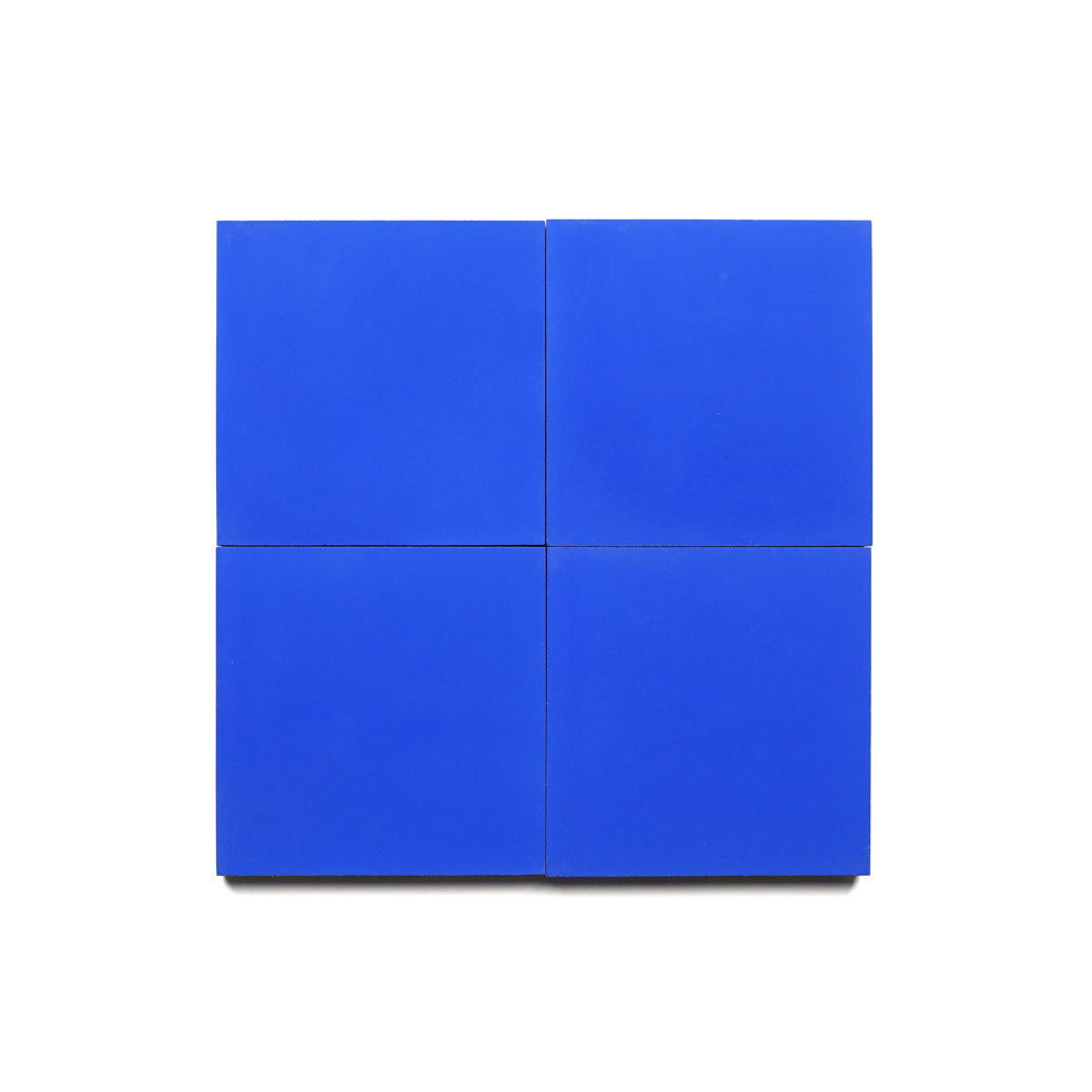 Four vibrant Zia Tile Elemental Blue 4x4 tiles are displayed in a 2x2 grid on a white background, creating a striking square—perfect as an accent for kitchen backsplashes.