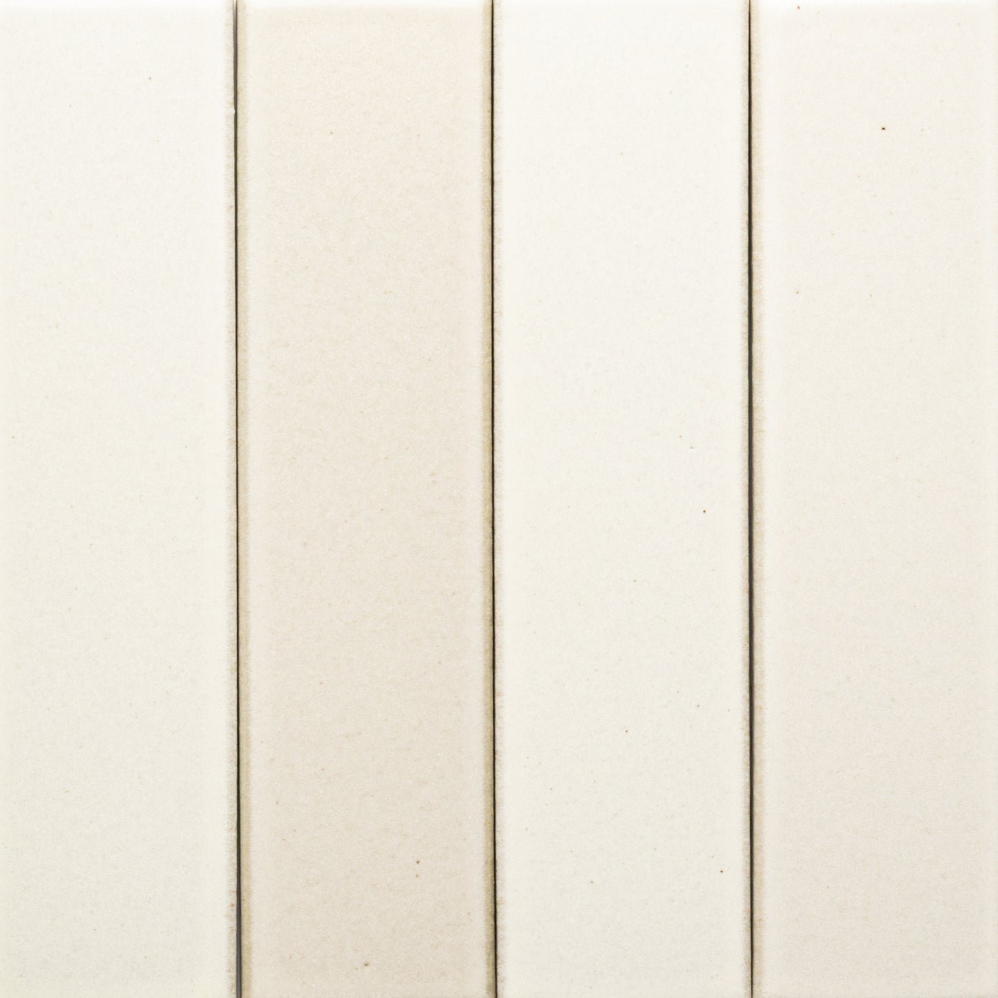 Four vertical, rectangular off-white Feather + Flat ceramic tiles by Zia Tile are arranged side by side, each separated by thin grout lines and featuring subtle color variations.