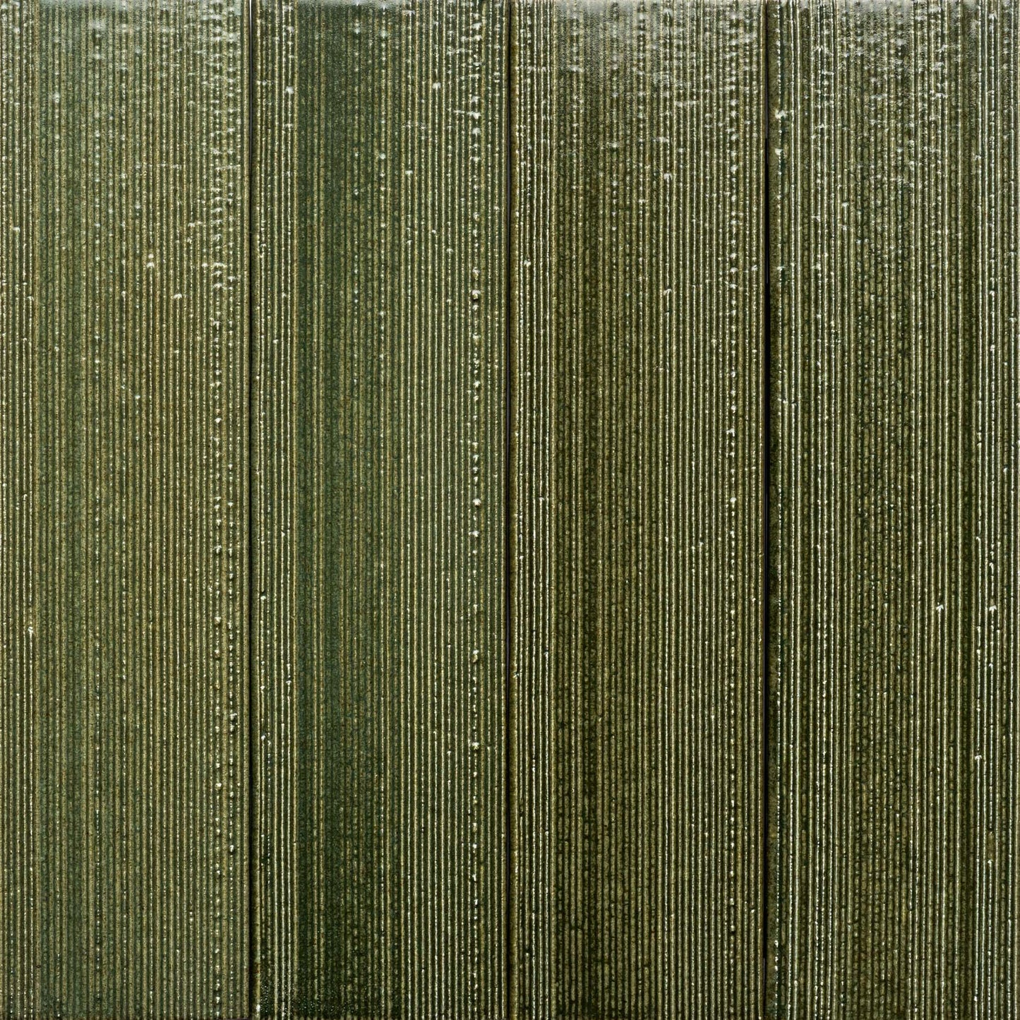 Frogtown + Etched by Zia Tile features a textured surface with vertical ridges in multiple shades of olive green, giving the tile a striped and tactile look.