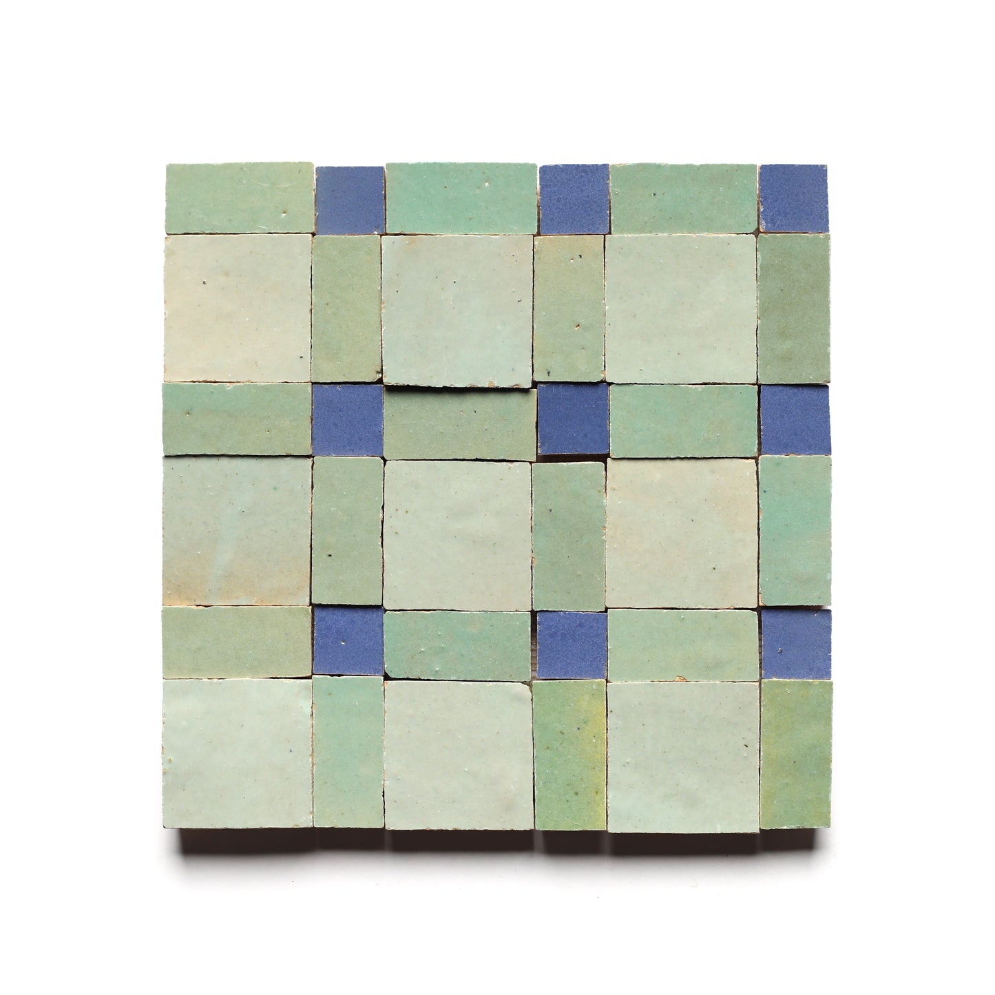The Gambit 7 by Zia Tile is a square tile mosaic with light green and blue Moroccan tiles in a geometric grid, ideal for a stylish kitchen backsplash on a white background.
