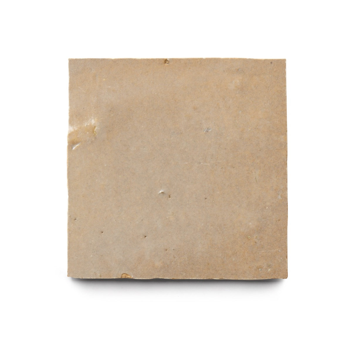 The vendor-unknown Glazed Earth 4x4 tile is a plain, square, light brown Moroccan zellige with a smooth surface and slight imperfections—ideal for stylish kitchen backsplashes, shown here against a white background.