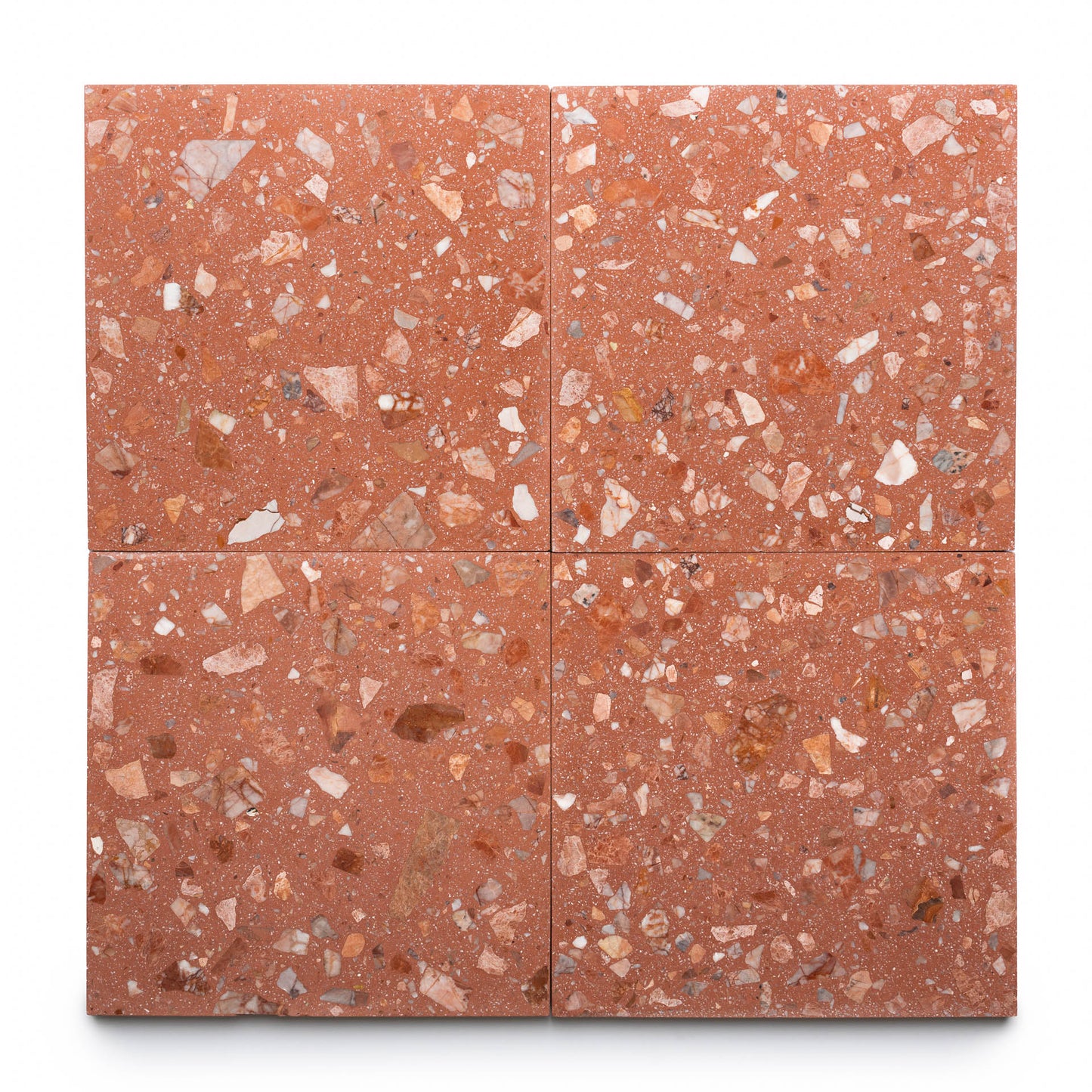 Four Guava 12x12 terrazzo cement tiles from Zia Tile, each featuring a unique mix of red, pink, and white stone chips—perfect for stylish kitchen backsplashes or sophisticated cement flooring.