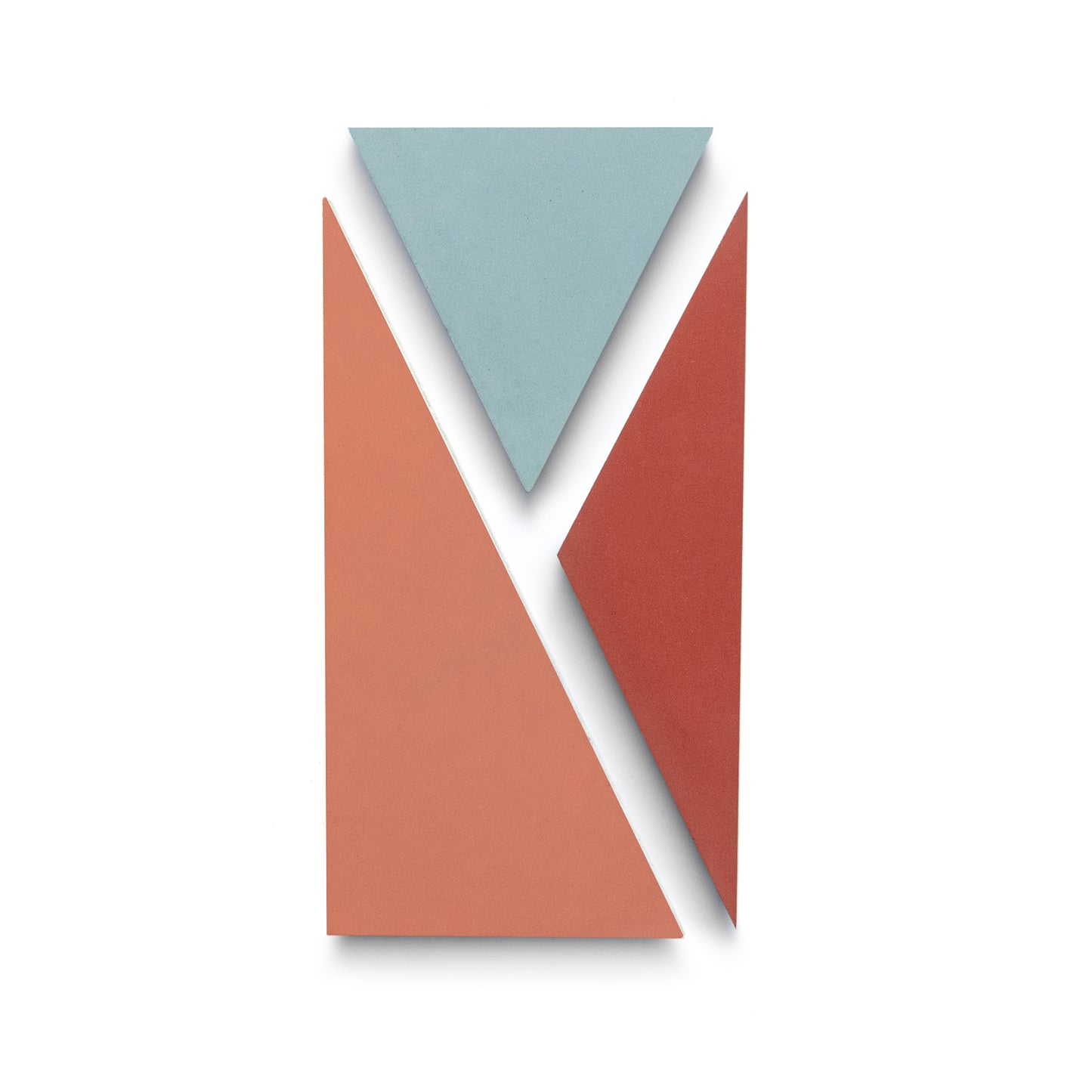 Three geometric shapes on white—a blue triangle at the top, a large peach triangle lower left, and a smaller red triangle lower right—capture the modern style of Zia Tile’s Kepler Set One handmade cement tile.