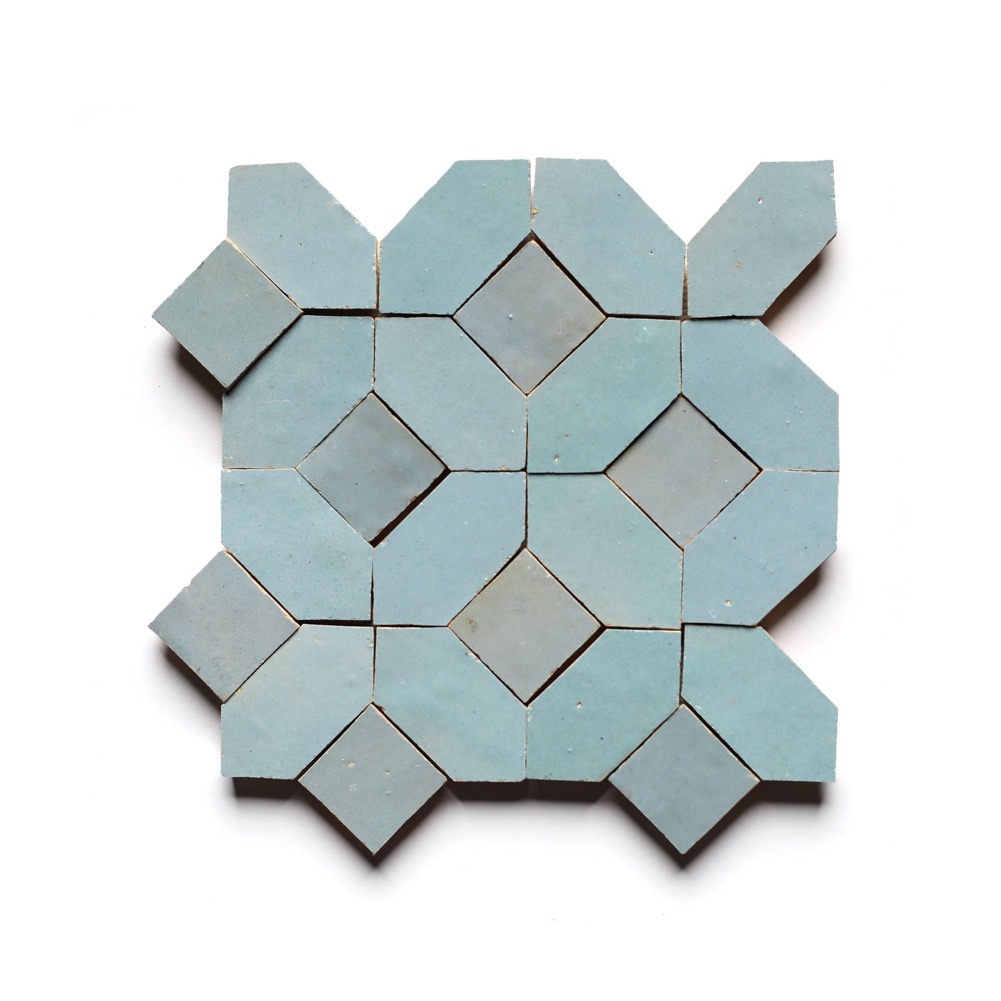 Lattice 5 by Zia Tile features a geometric pattern of light blue zellige tiles with octagons and diamonds on a white background, ideal for a stylish kitchen backsplash.