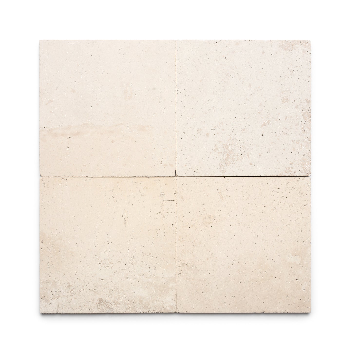 Four Mesa 12x12 tiles by Zia Tile, light beige Cantera stone with natural variations and subtle textures, arranged in a two-by-two grid on a white background.