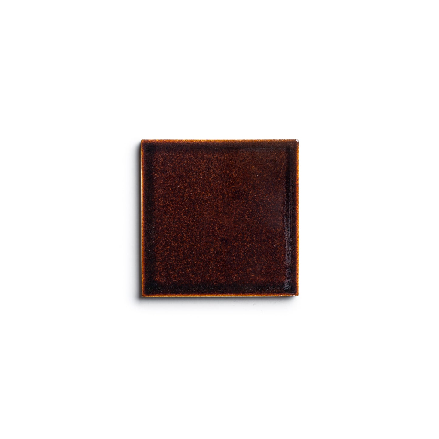 A square, dark brown Molasses 4x4 ceramic plate by Zia Tile with a glossy finish, seen from above on a plain white background.