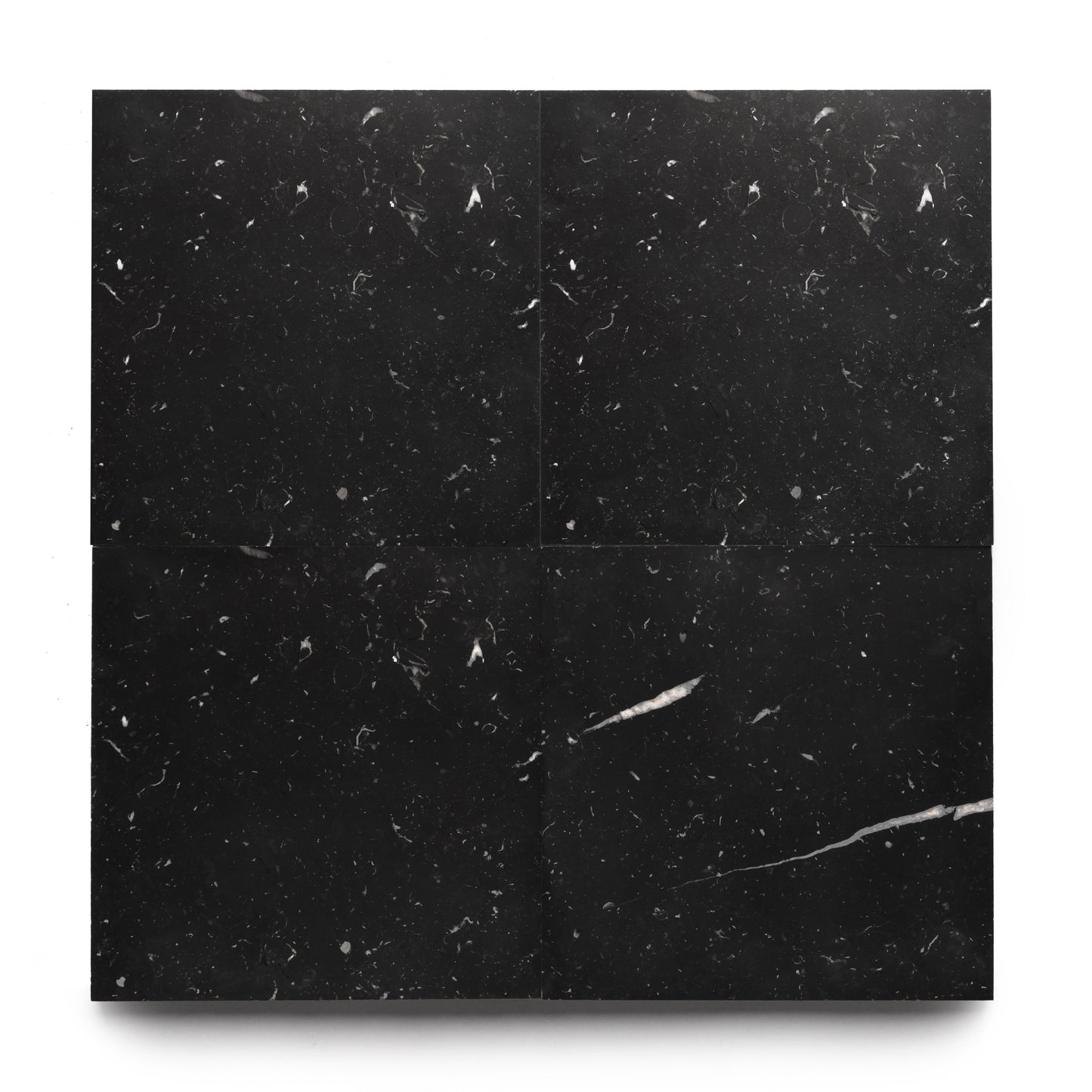 Four Zia Tile Nero Marquina 12x12 black marble tiles, with subtle white veining and fine light specks, are arranged in a square on a white background.