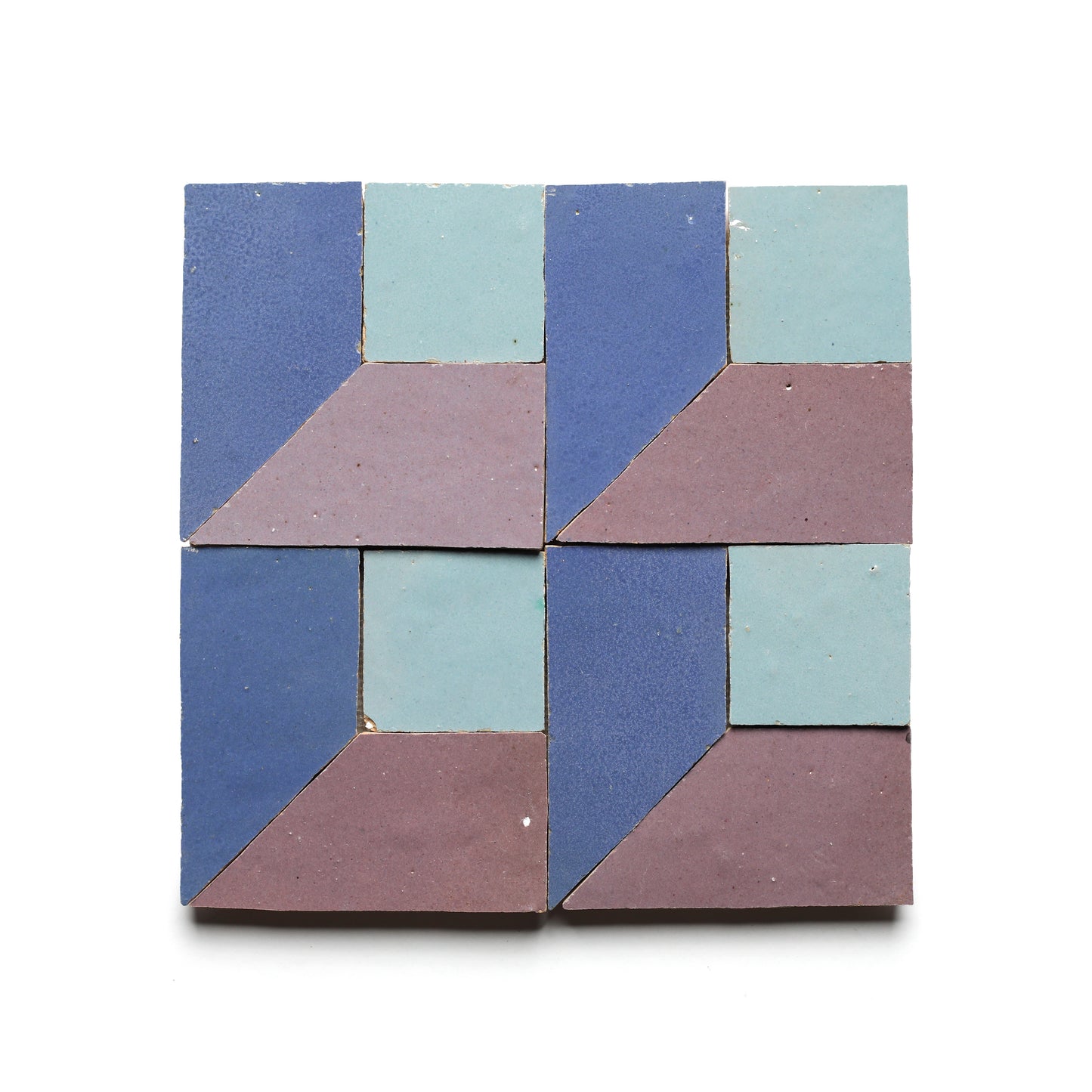 Perpetual Check 4 by Zia Tile features four square ceramic tiles in a grid, each with blue, teal, and mauve color blocks. The modern geometric design is inspired by Moroccan tile patterns and set against a white background.