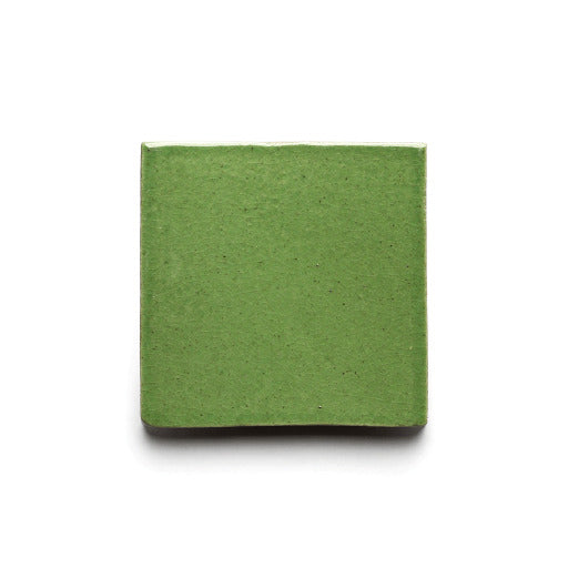 A single glossy green Primavera 4x4 ceramic tile by Zia Tile, inspired by ceramic arts, is centered on a plain white background.