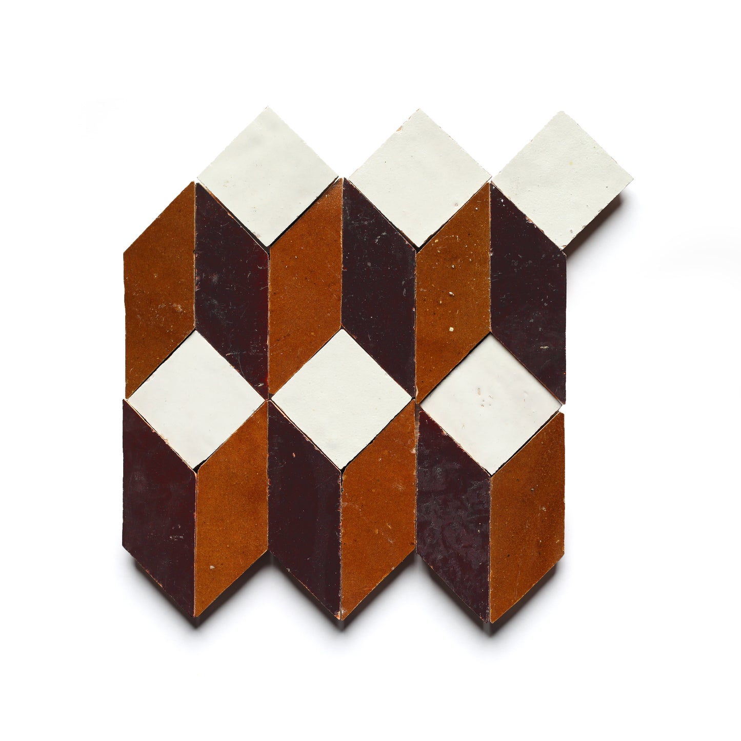 Prismatic 6 by Zia Tile features geometric diamond and parallelogram shapes in white, brown, and dark red on a white background—perfect for a stylish kitchen backsplash inspired by Moroccan zellige mosaics.