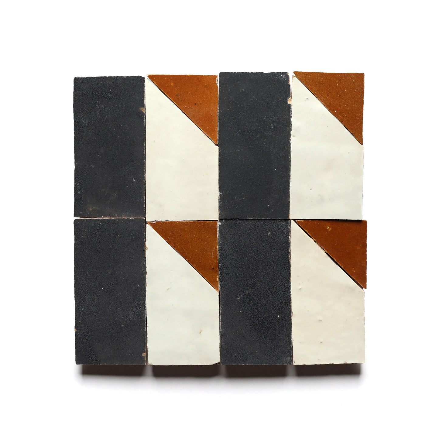 The Radian Inline 2 by Zia Tile features four square tiles in a 2x2 grid, each split diagonally into black, white, and brown sections, forming a geometric pattern ideal for a Moroccan-inspired kitchen backsplash.