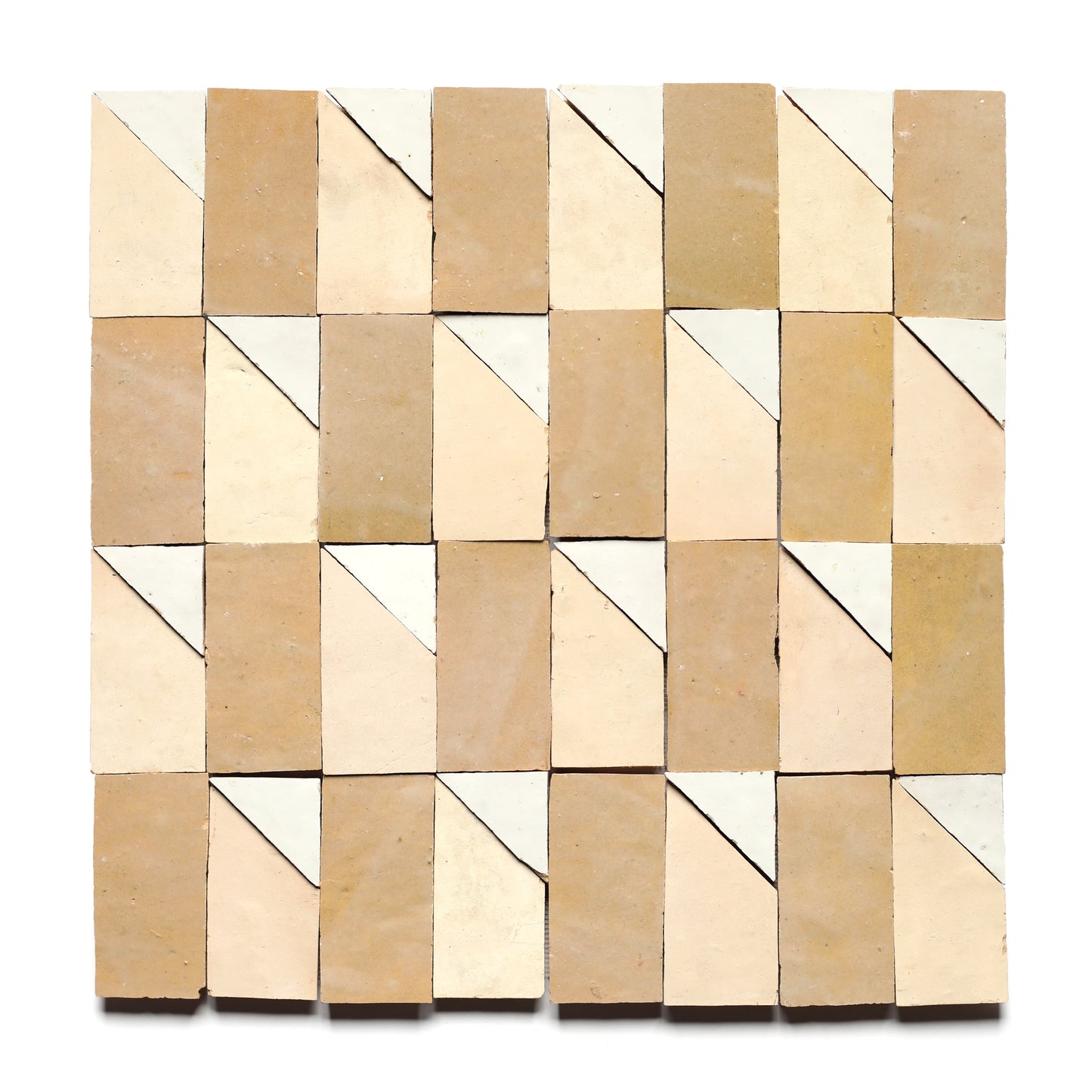 Radian Offset 4 by Zia Tile features a grid of rectangular handmade tiles in beige, tan, and white, each split diagonally into two triangles for a striking geometric pattern on a white background.