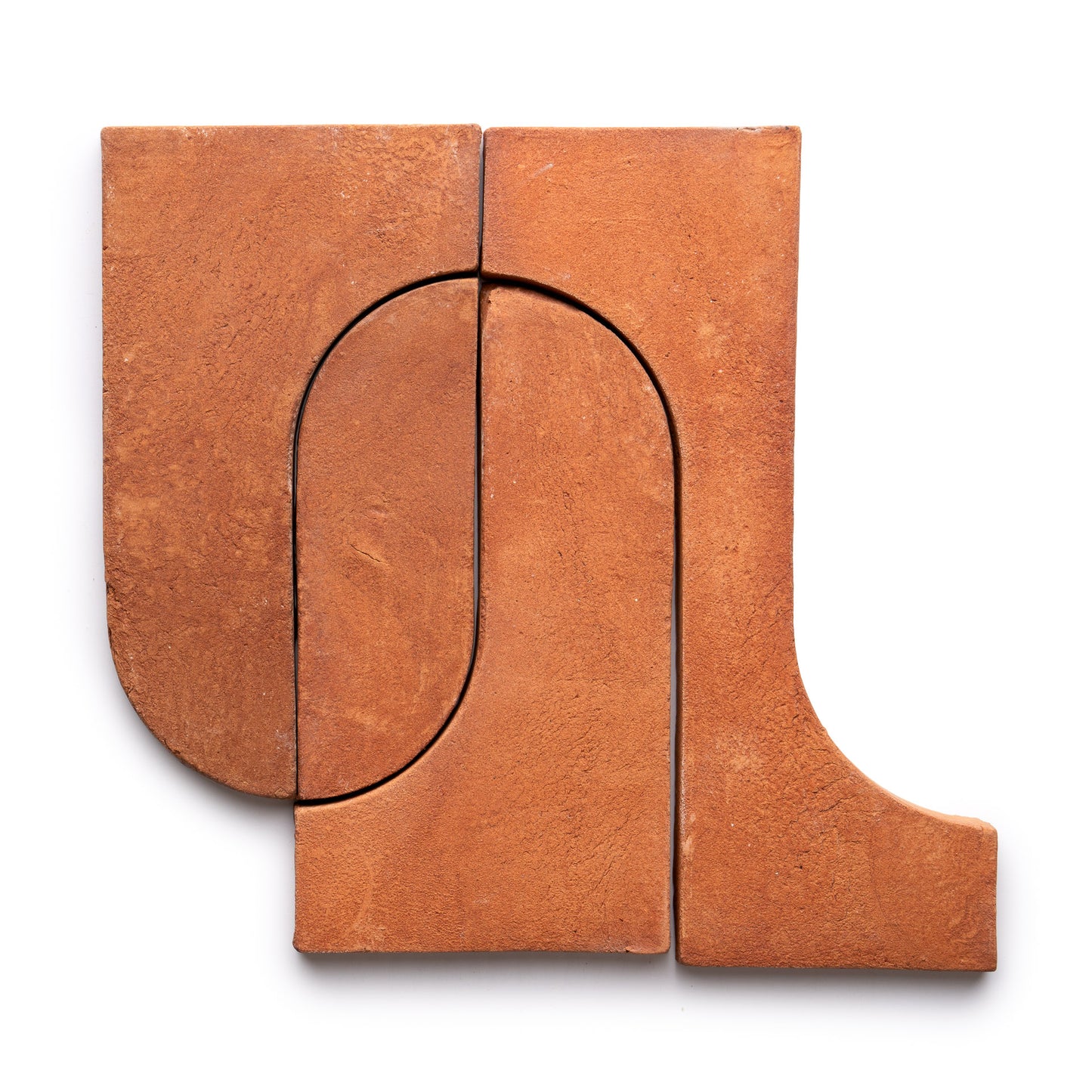 Three Durango + Red Clay tiles by Zia Tile arranged in a geometric, abstract pattern with curved and straight edges, forming an arch-like shape on a white background.