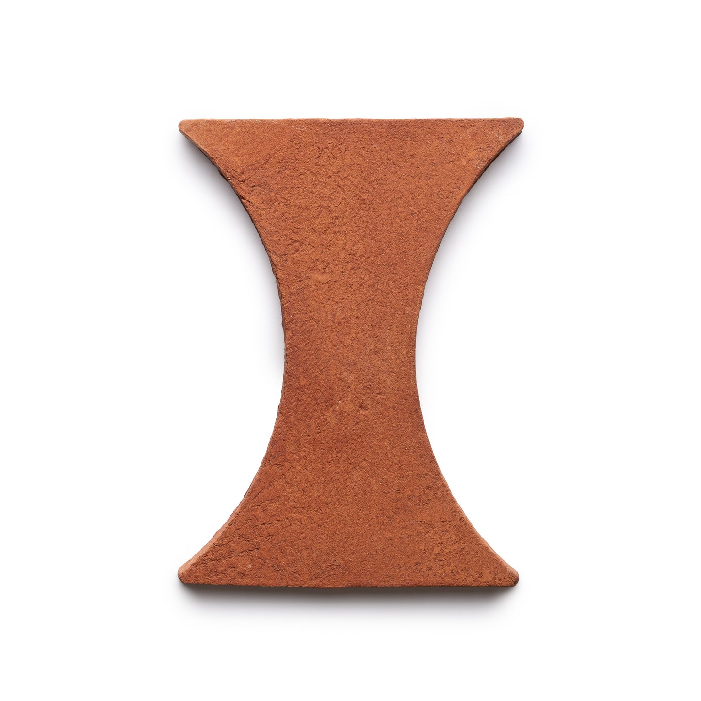 A single Oaxaca + Red Clay brick by Zia Tile, featuring a reddish-brown, hourglass shape and rough texture, displayed on a white background.