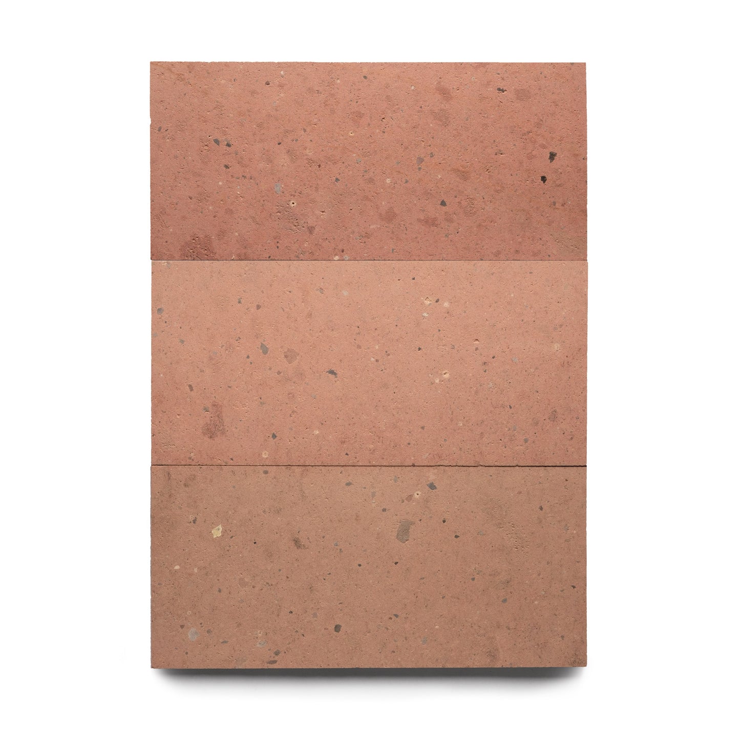 Three Sedona 12x24 tiles by Zia Tile are arranged vertically on a white background, each displaying small speckles and subtle texture variations typical of natural volcanic stone.