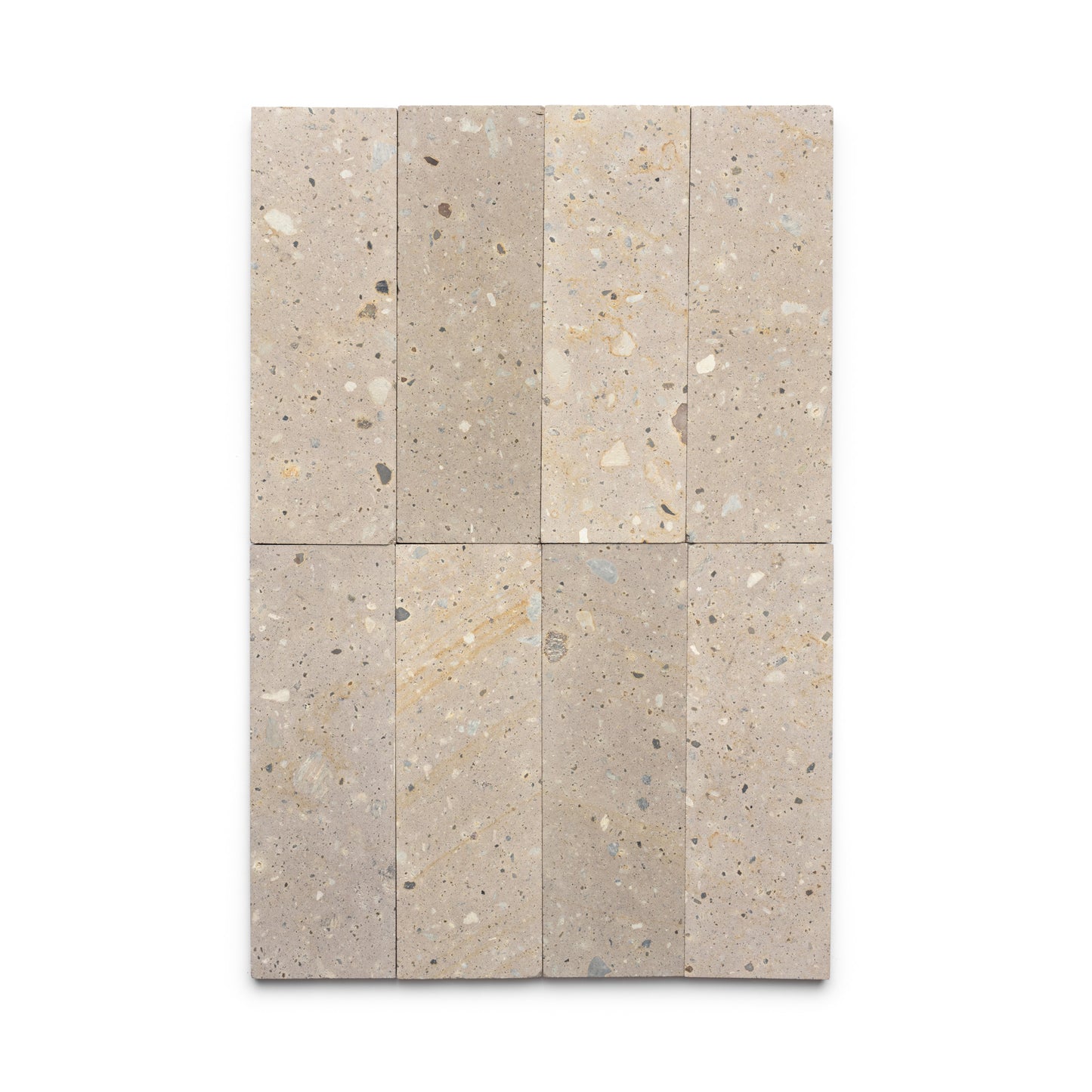 Six Sierra 4x12 tiles by Zia Tile, inspired by Mexican Cantera stone, are arranged in a 2x3 grid. Each rectangular beige tile features small, irregular gray, tan, and white specks for a natural stone texture.