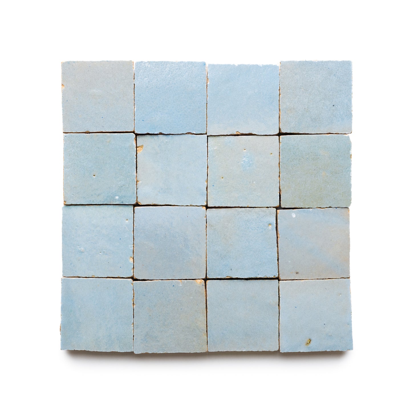 Sixteen Skylight 2x2 pale blue handmade zellige tiles arranged in a 4x4 grid on a white background, each showing subtle color and texture variations with minor imperfections for an artisanal look.