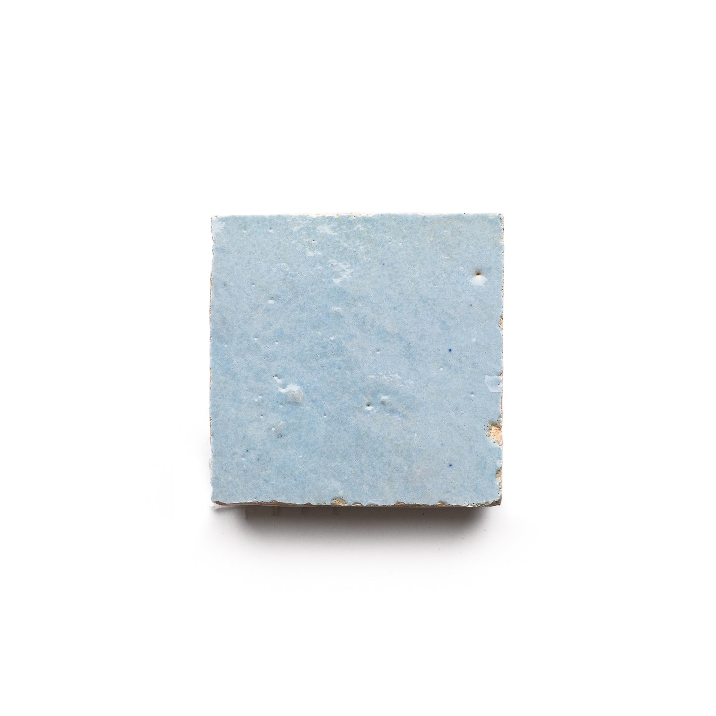 The Skylight 2x2 is a single square Moroccan tile with a light blue, subtly textured surface and minor imperfections, shown against a white background.