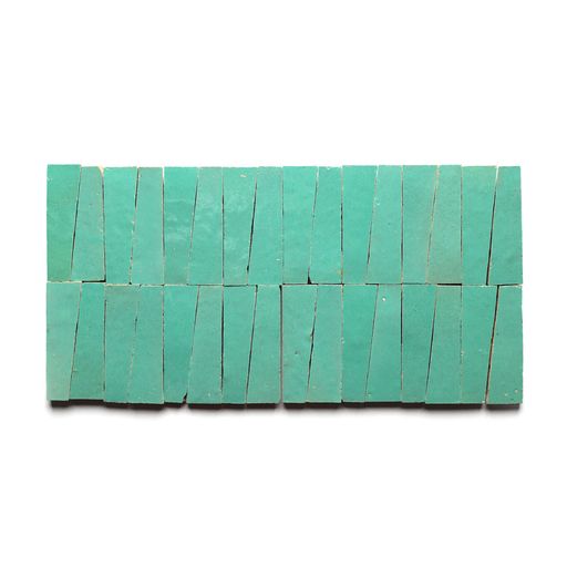 Two horizontal rows of Zia Tiles Tulum Trapezoid tiles, arranged with visible gaps, showcase turquoise irregular trapezoids that evoke geometric mosaics and traditional Moroccan tile design.