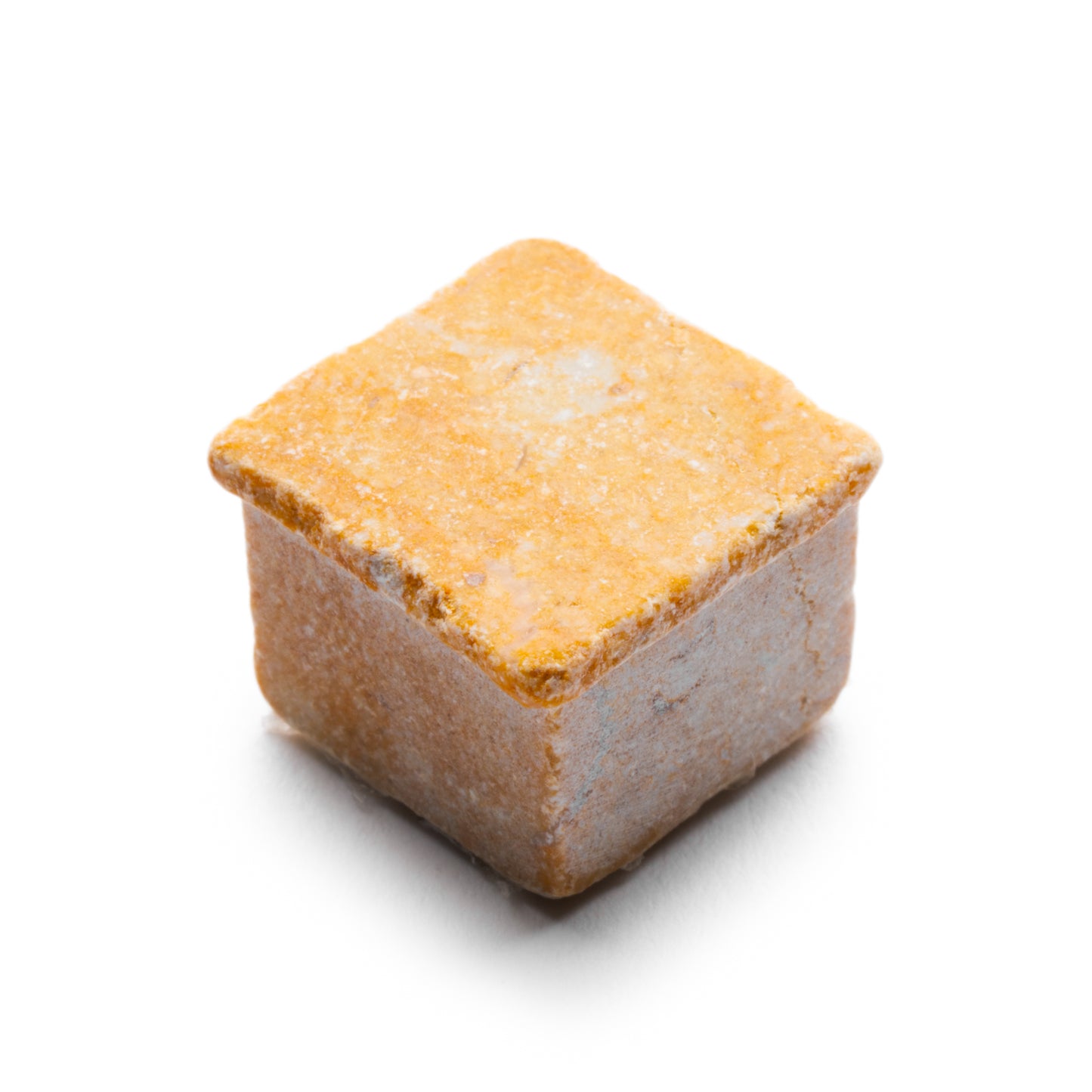 A close-up of a single Ventaglio in Giallo Reale tile by Zia Tile, showcasing its yellow-orange hue and textured edges against a white background.