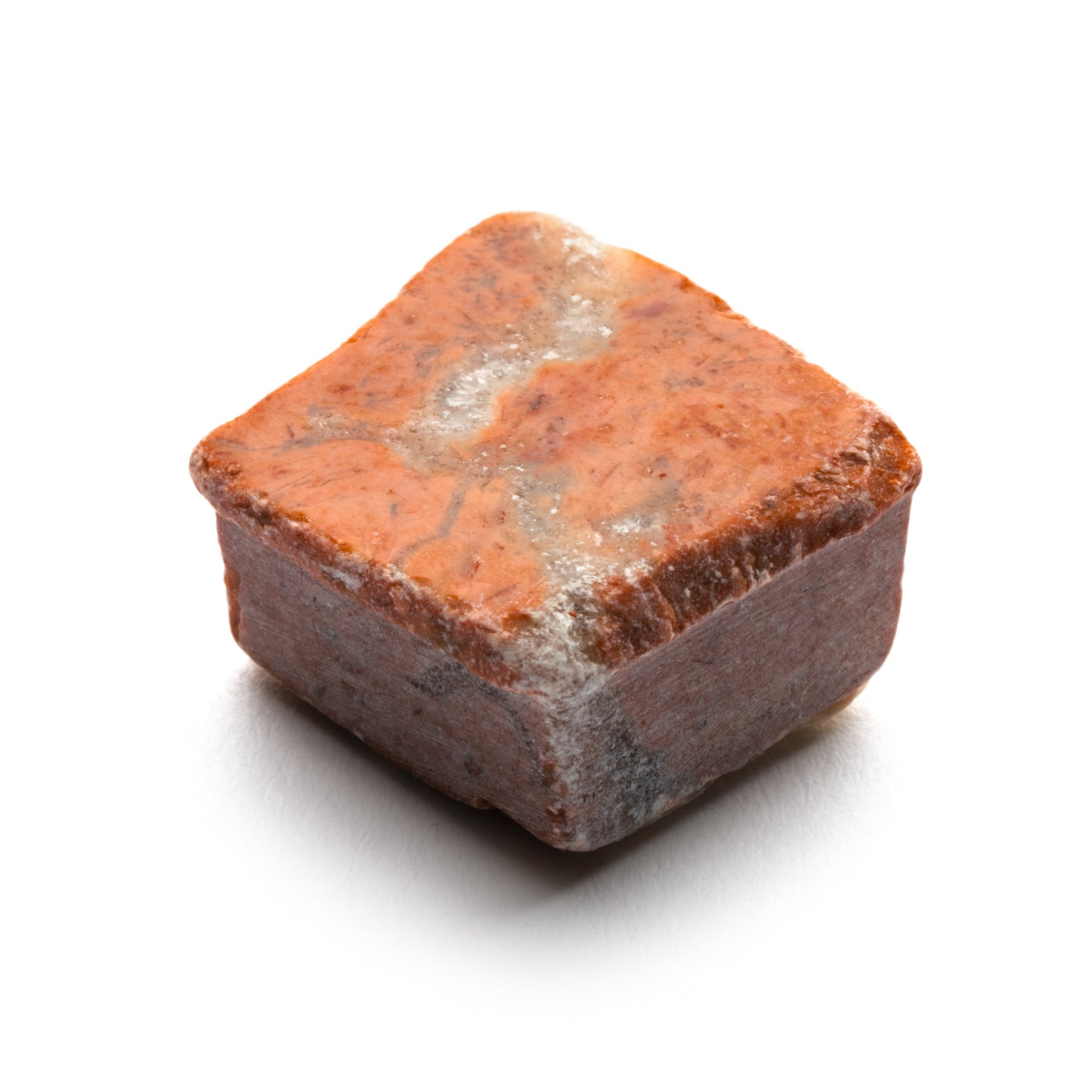 The Ventaglio in Rosso Alicante by Zia Tile is a single reddish-brown tile with rough, uneven surfaces and a marbled streak through its center, shown against a white background.