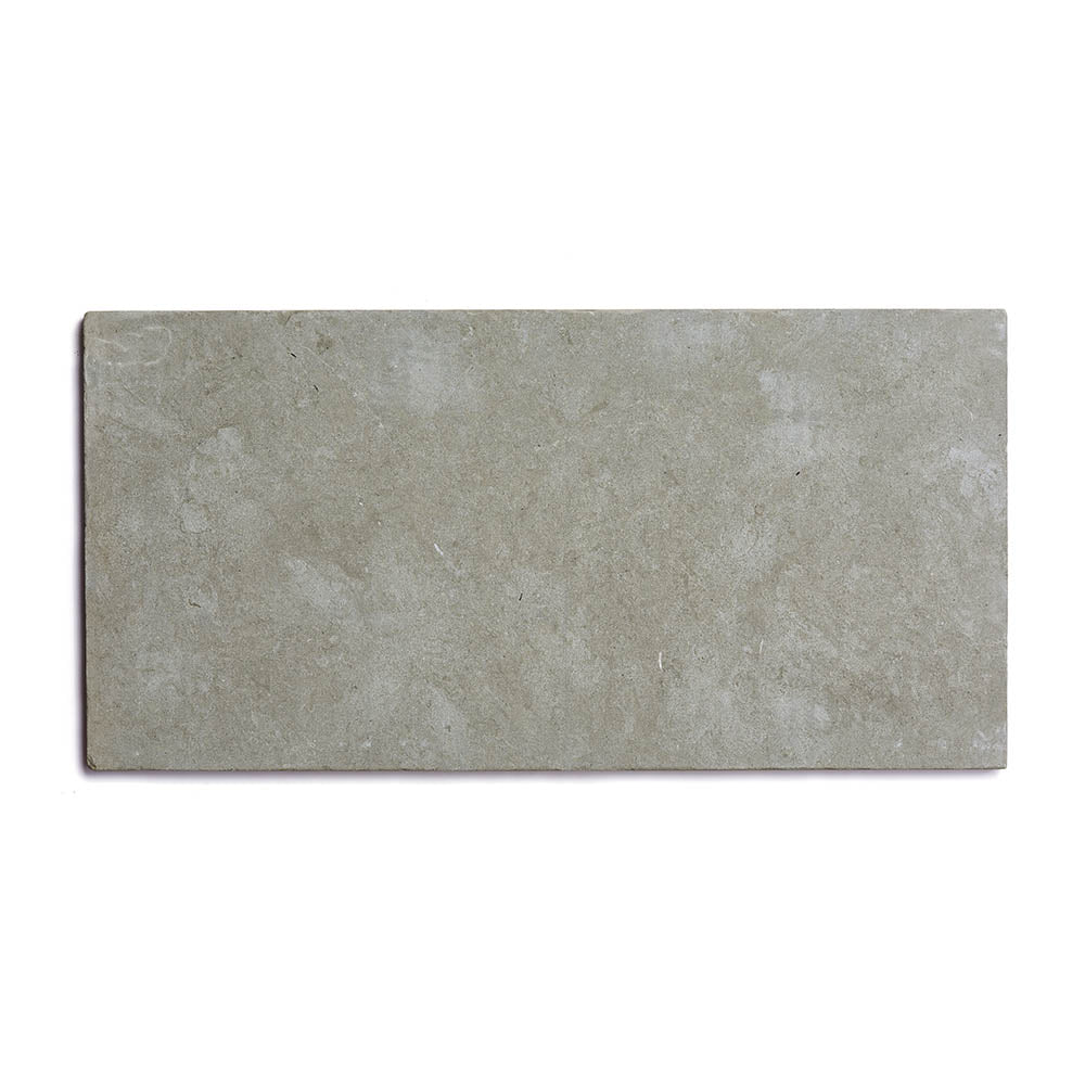 Basilica 12x24 + Honed is a rectangular, light gray Moroccan limestone tile featuring a smooth, lightly textured surface with subtle natural patterns inspired by Fez stone tiles.