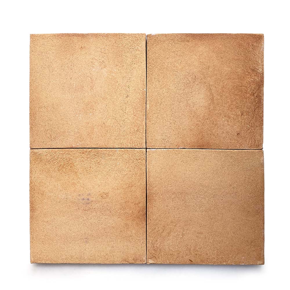 Four 8x8 Square + Adobe tiles by Zia Tile are arranged in a 2x2 grid on a white background, displaying rustic orange-brown variations and subtle texture characteristic of handmade Cotto from San Miguel de Allende.