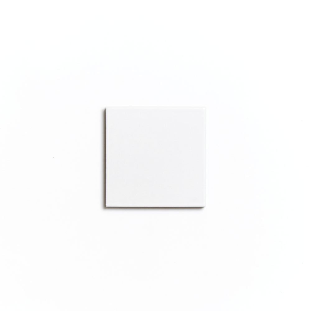 The Alpha White 4x4 ceramic tile by Zia Tile is centered on a white background, highlighting its matte finish and creating a minimal, clean look.