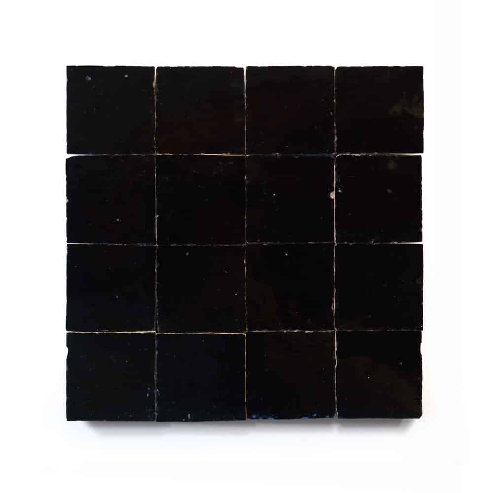 A 4x4 square grid of Zia Tiles Carbon Black 2x2 ceramic samples with a glossy finish is displayed on a white background.