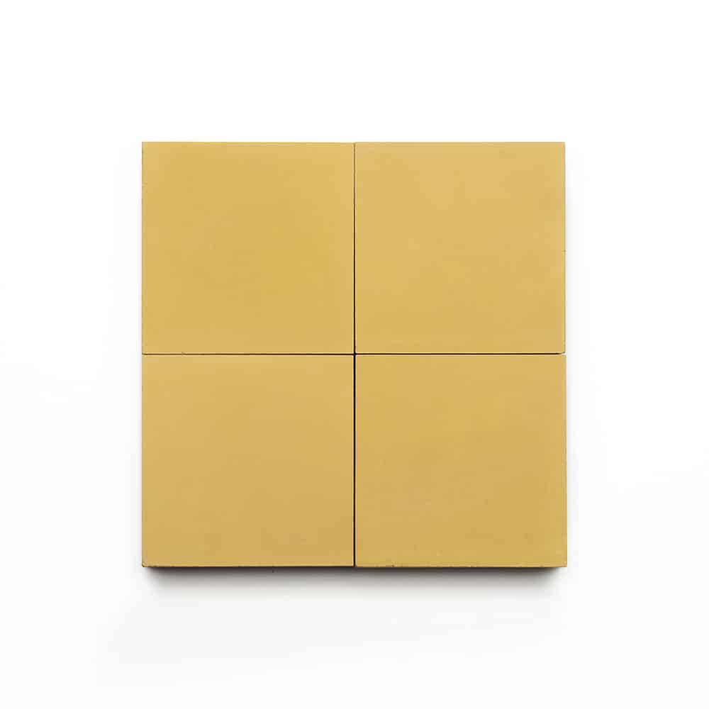 Four Cadmium 4x4 mustard yellow cement tiles arranged in a 2x2 grid on a white background—ideal for adding a vibrant touch as a kitchen backsplash.