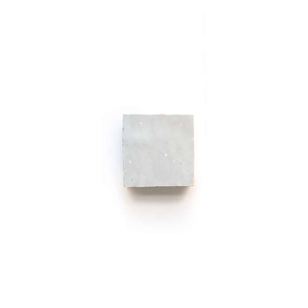 A single Casablanca 2x2 light gray tile is centered on a plain white background, casting a faint shadow below.
