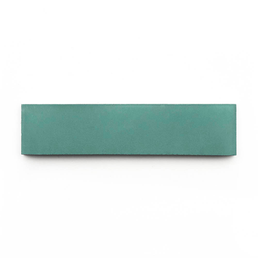 An Everglade 2x8 rectangular subway tile, flat and green, lies horizontally on a white background.