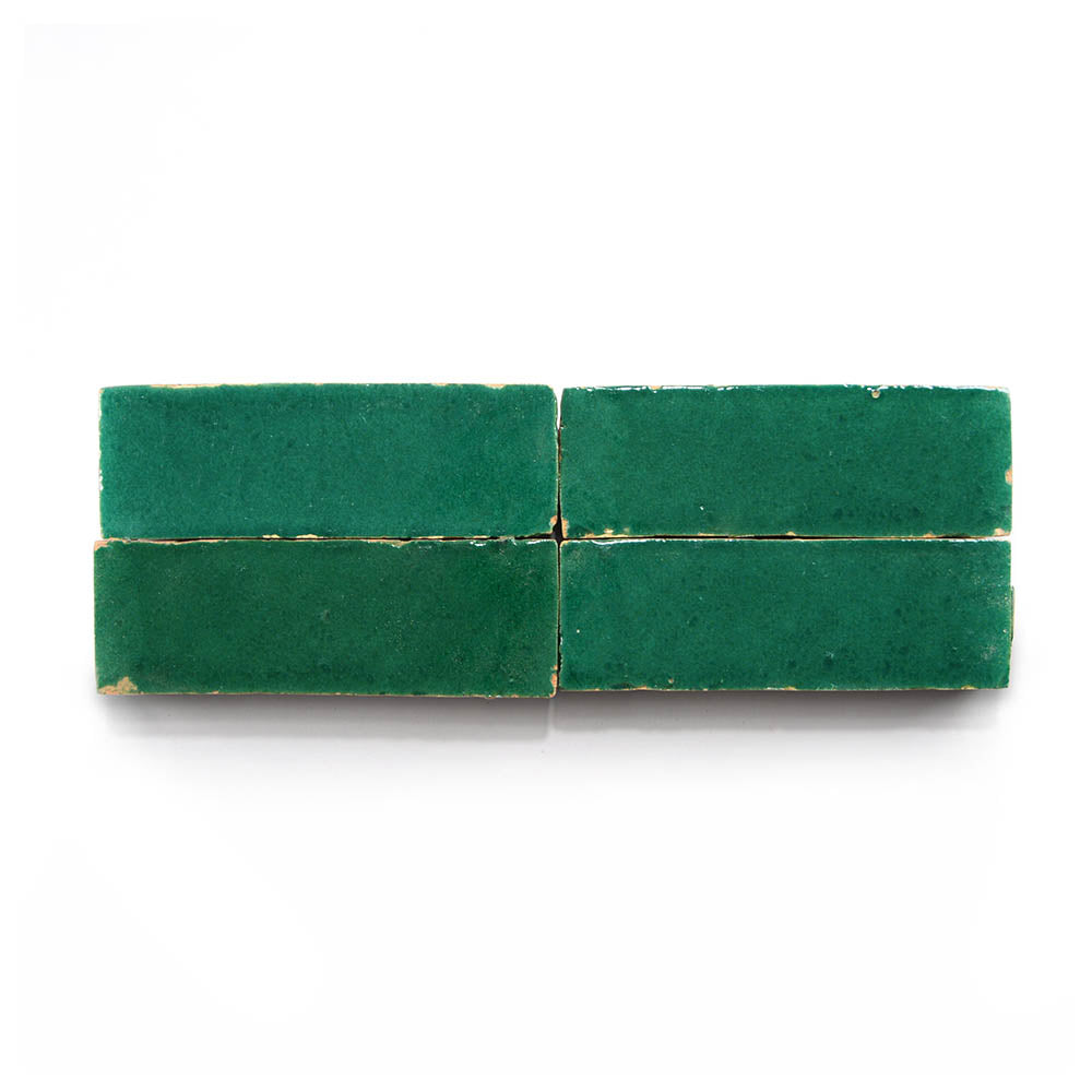Four Jade 2x6 rectangular zellige tiles are lined up horizontally on a white background, showing slight gaps and worn edges—ideal for a unique Moroccan-style kitchen backsplash.