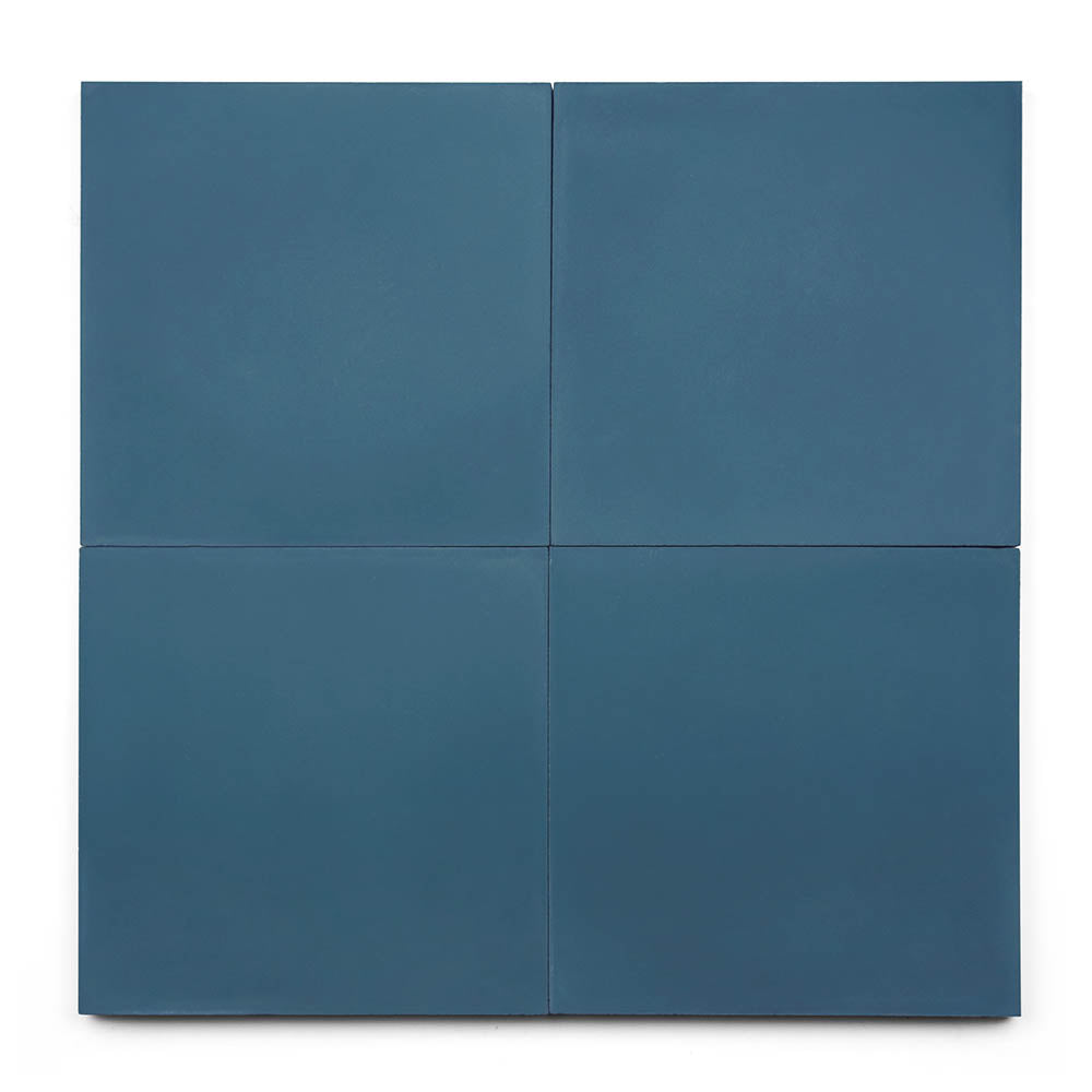 Four handcrafted Midnight 8x8 matte cement tiles, arranged in a 2x2 grid, create a striking display against a white background.