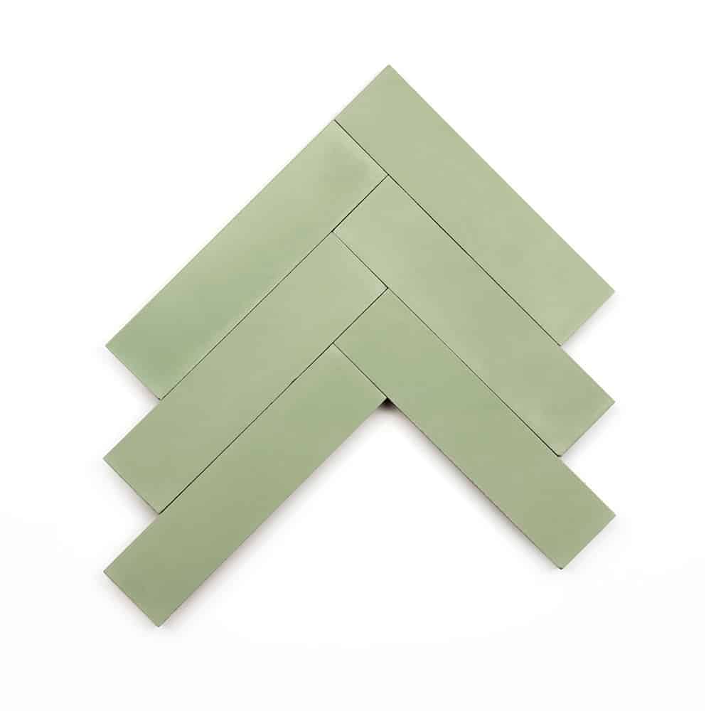 Six rectangular Nile 2x8 cement tile samples by vendor-unknown, in light green, are arranged in a herringbone pattern on a white background.