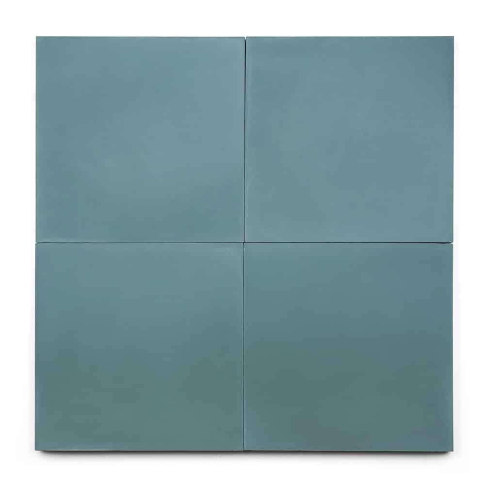 Four square Ocean 8x8 tiles in light blue-green are arranged in a seamless 2x2 grid, creating a minimalist look ideal for a fresh kitchen backsplash. The smooth, uniform surface evokes ocean cement tile inspiration.