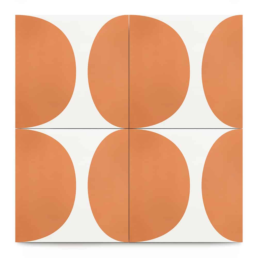 The Pomelo Terra Cotta 8x8 tile features four square cement tiles in a grid, each with a bold orange semi-oval on white. The shapes meet at the center, creating a symmetrical, abstract midcentury modern pattern.