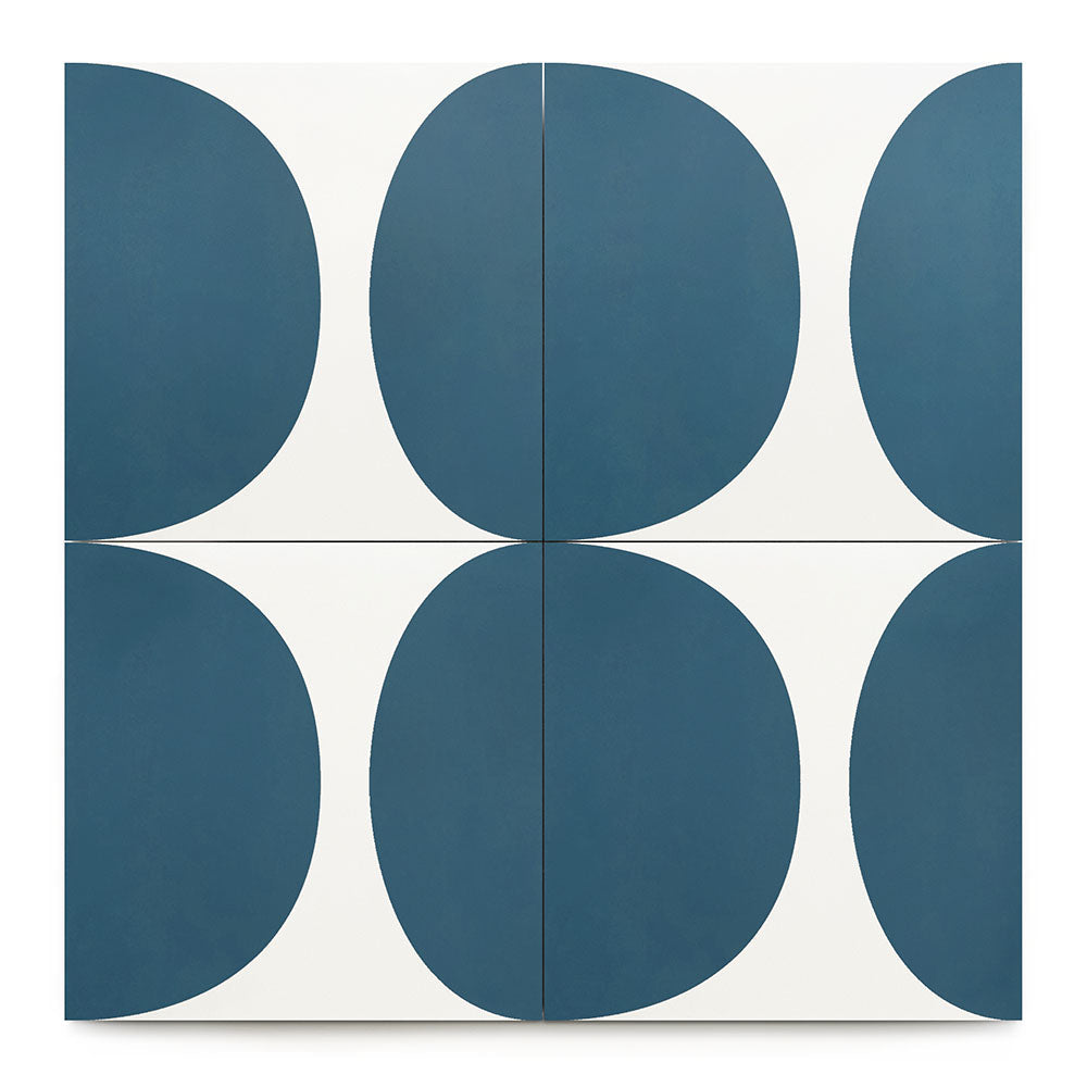 The Pomelo Midnight 8x8 features four square cement tiles in a grid, each showcasing a blue semicircle on white. Together, they create a striking geometric pattern with intersecting curves at the center.