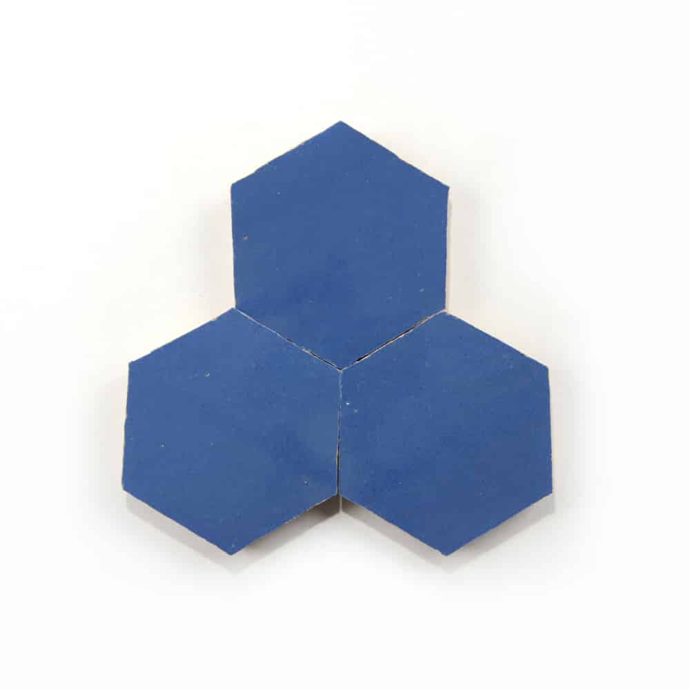 Three Portuguese Blue Hex tiles from Zia Tile are arranged edge to edge against a white background, showcasing the brand's modern style.
